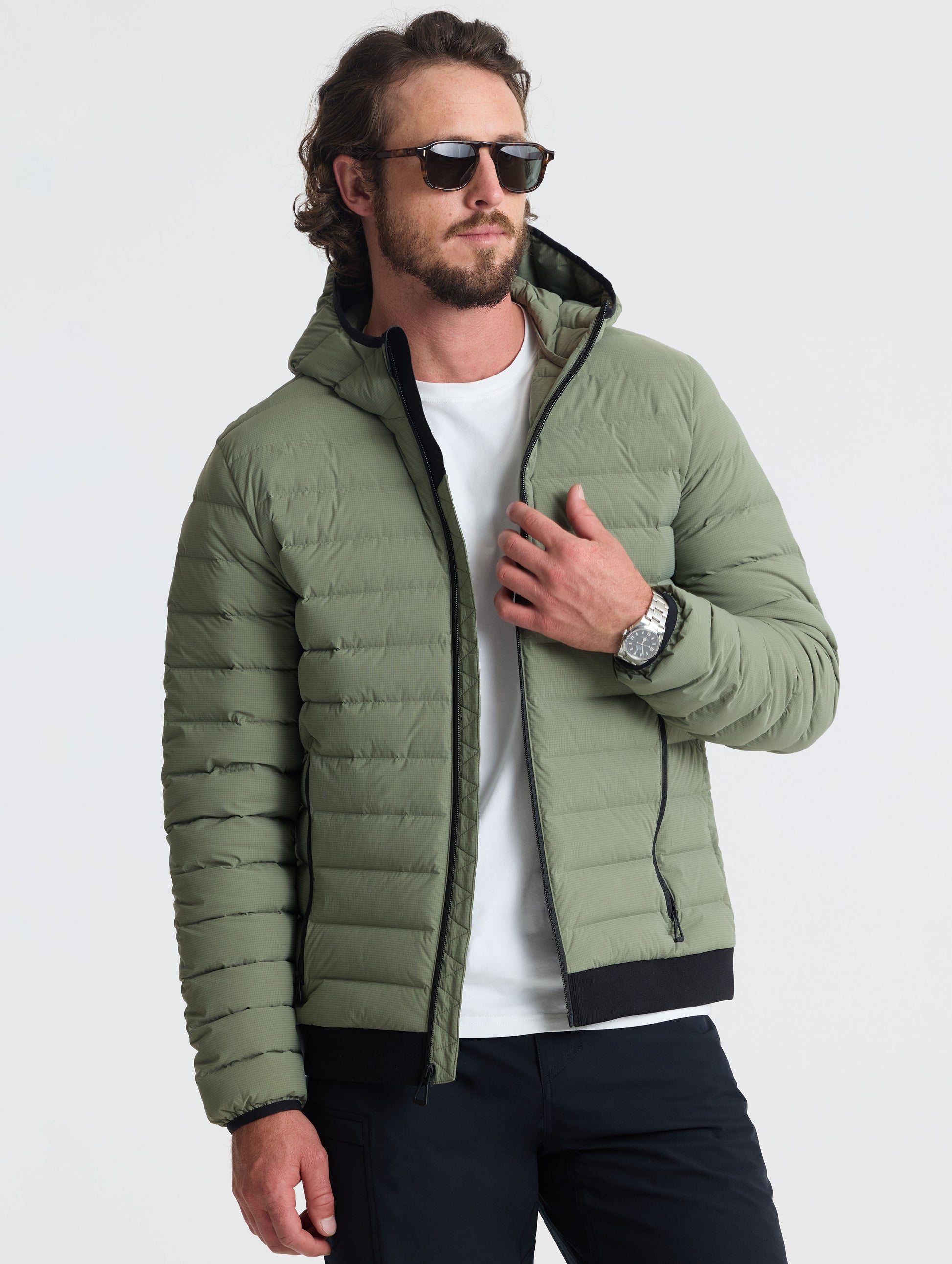 Front view of man wearing unzipped Launch Full-Zip Hooded Jacket in Fern Green from AETHER Apparel.