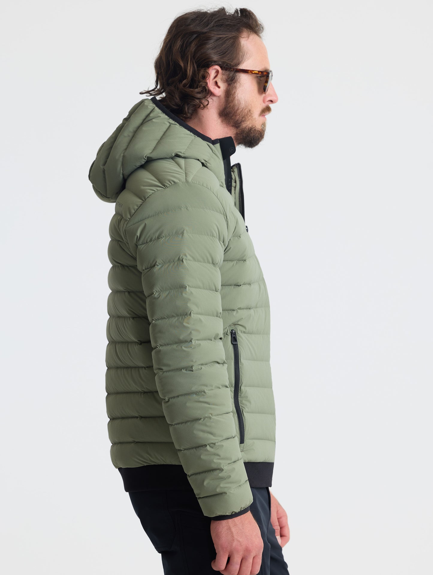 Right profile view of man wearing Launch Full-Zip Hooded Jacket in Fern Green from AETHER Apparel.