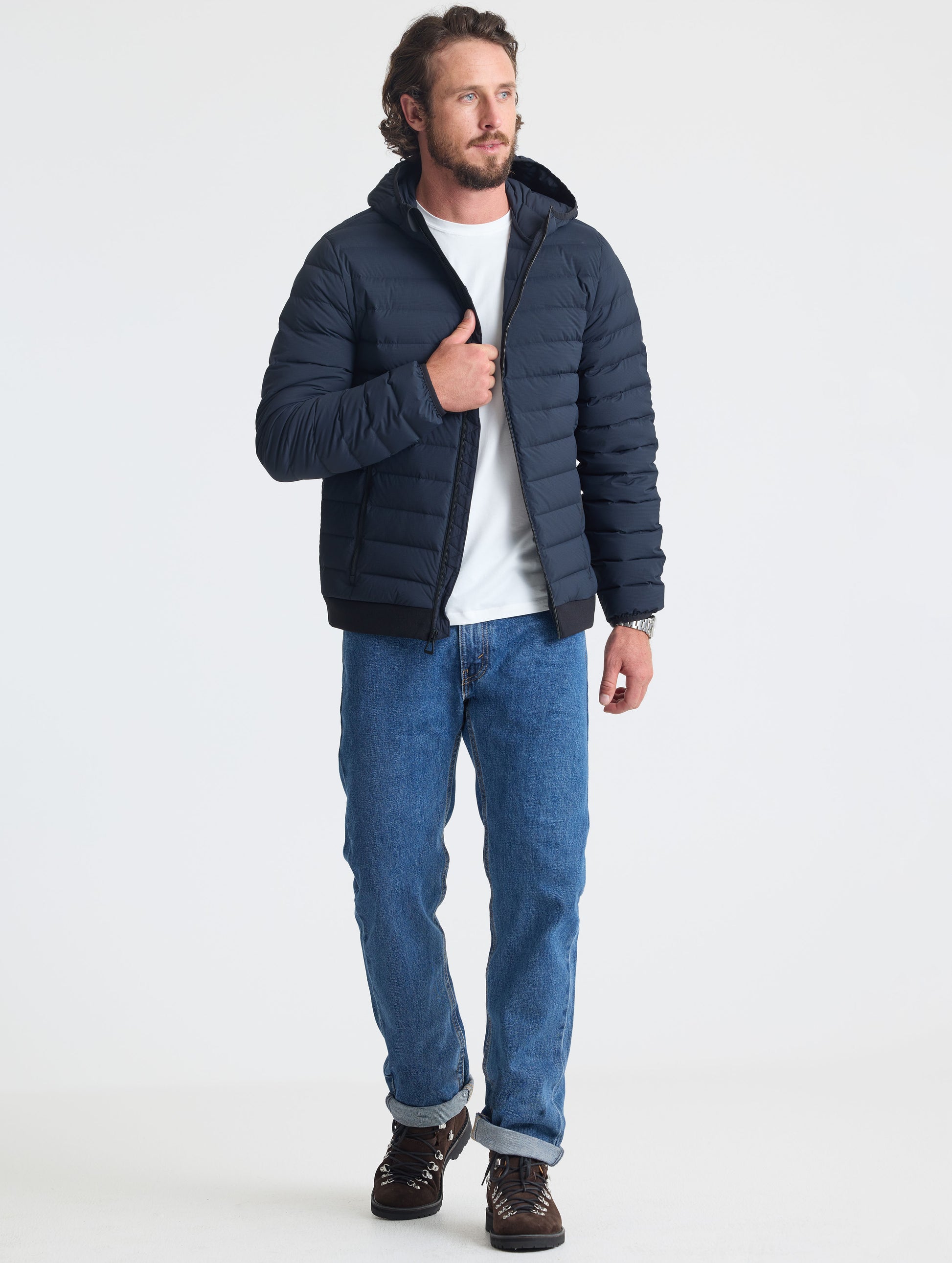 Full body view of man wearing Launch Full-Zip Hooded Jacket in Onyx Black from AETHER Apparel.