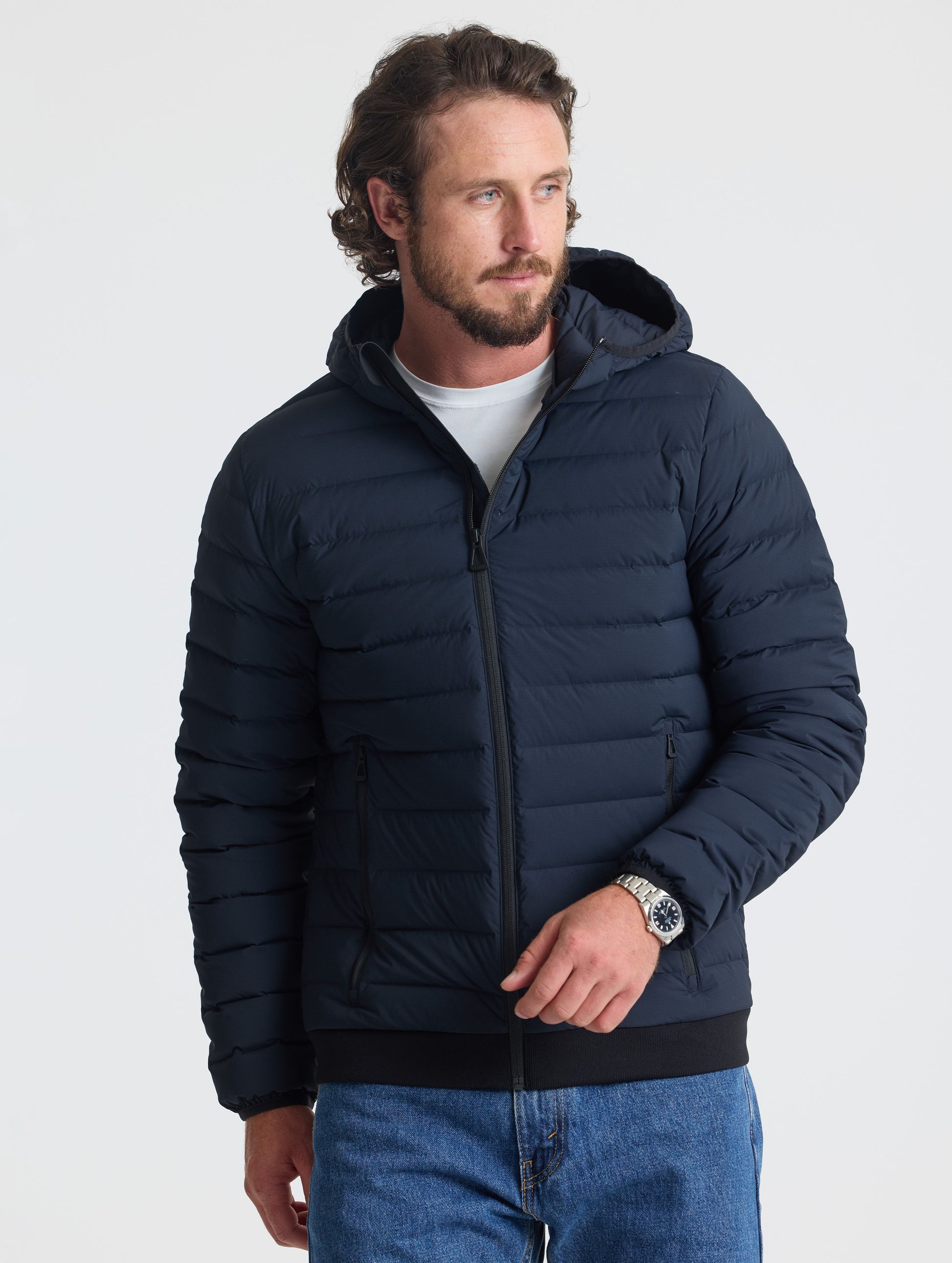 Front view of man wearing Launch Full-Zip Hooded Jacket in Onyx Black from AETHER Apparel.