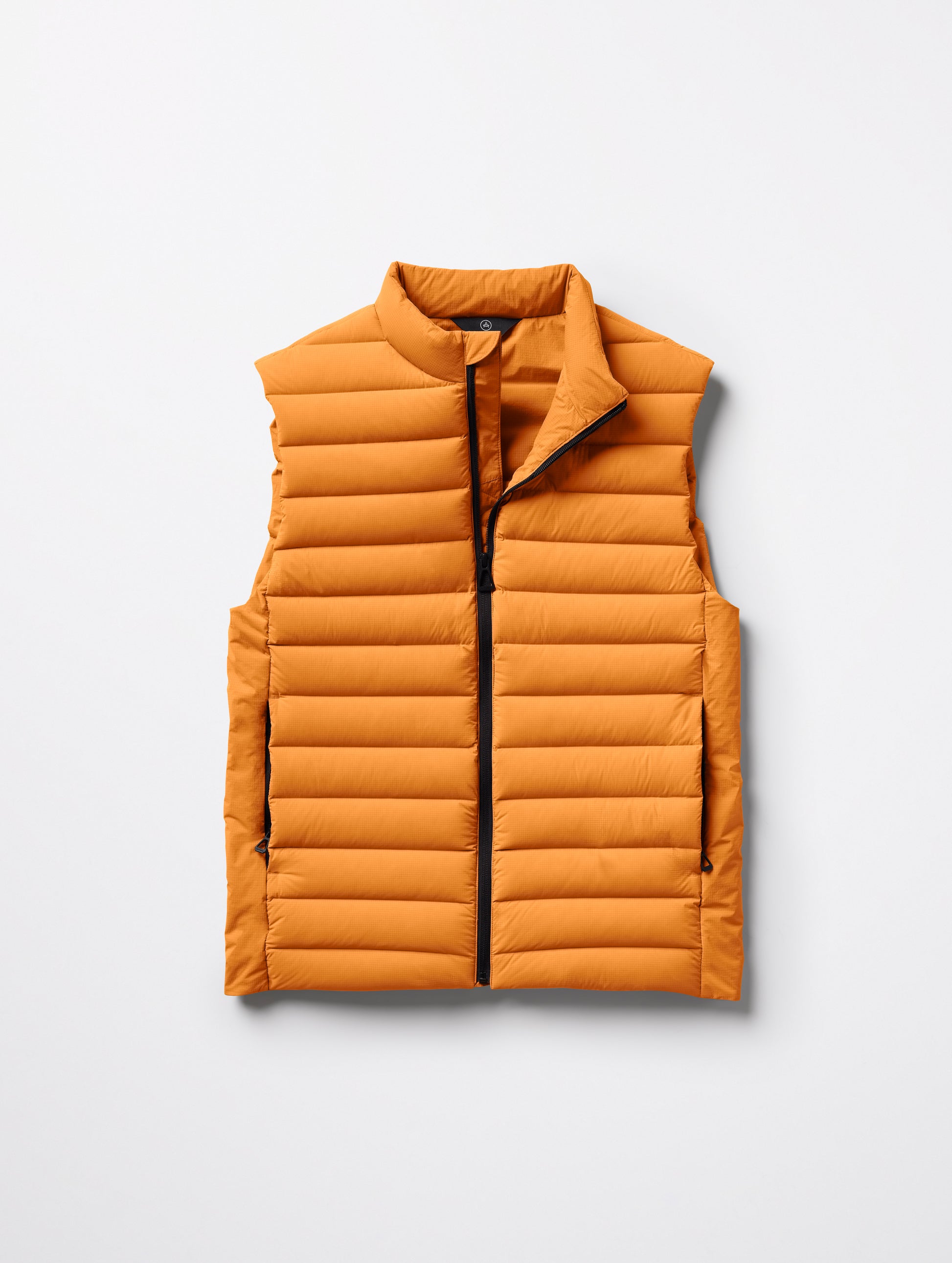 Flat lay of men's Launch Vest in Midas Orange from AETHER Apparel.