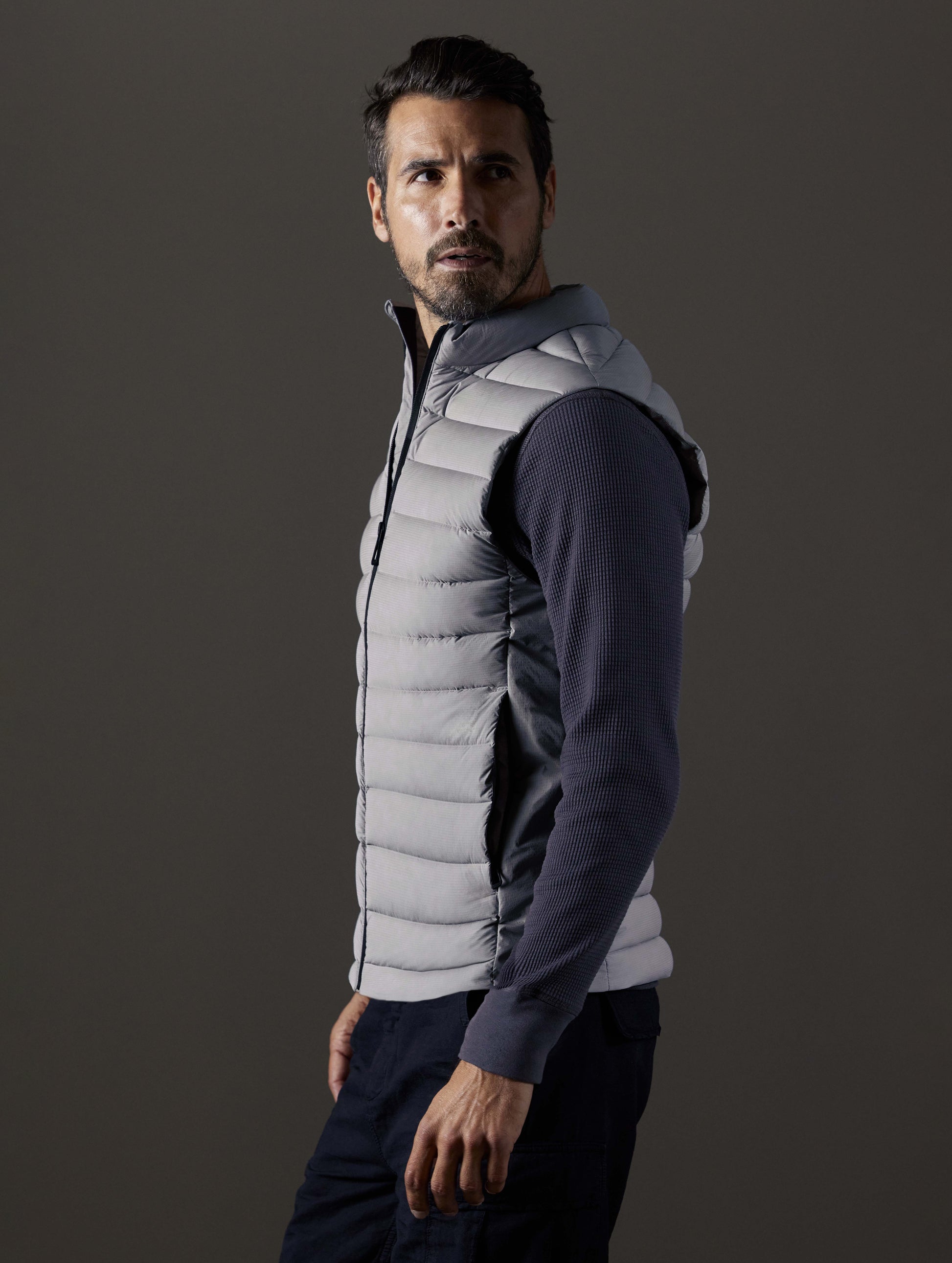 man wearing grey insulated vest from AETHER Apparel