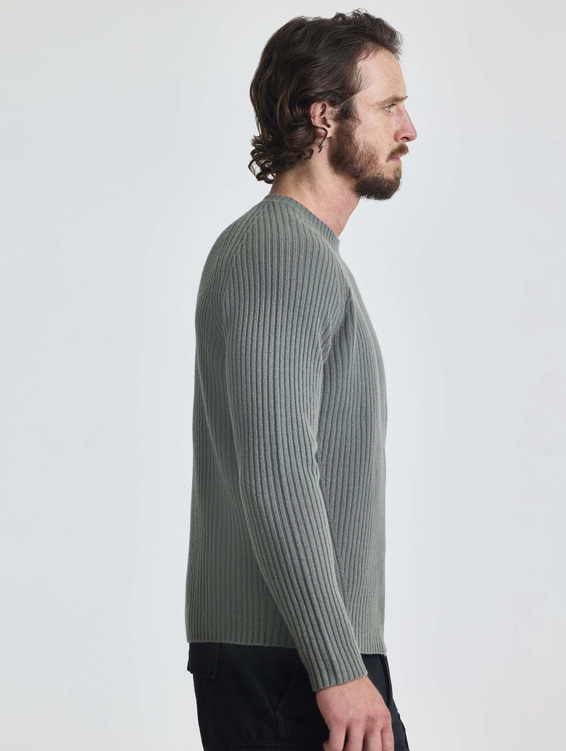 Right profile of man wearing Lyon Sweater in Gunmetal grey from AETHER Apparel.