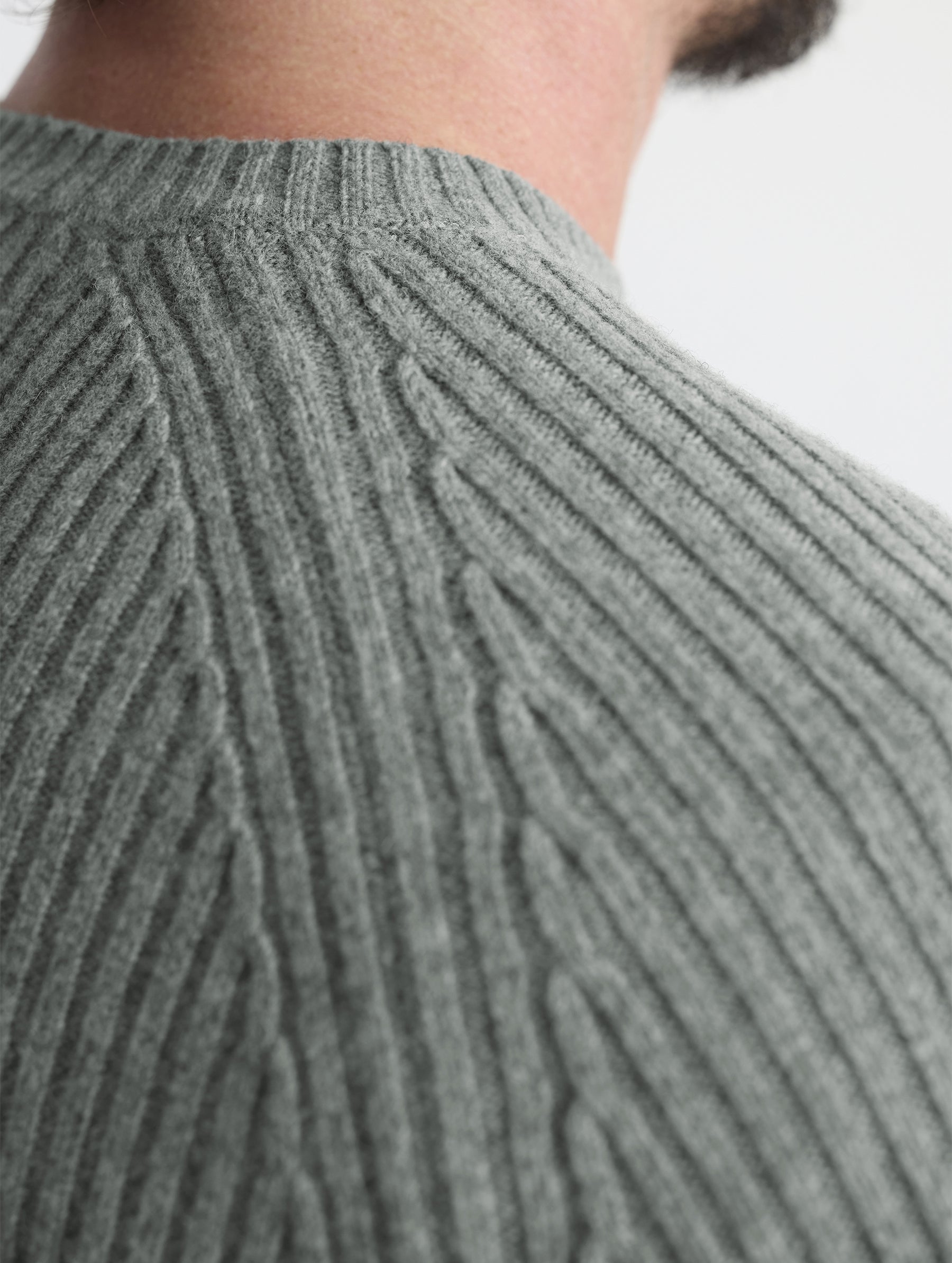 Rear closeup detail view of wearer's right shoulder of Lyon Sweater in Gunmetal grey from AETHER Apparel.
