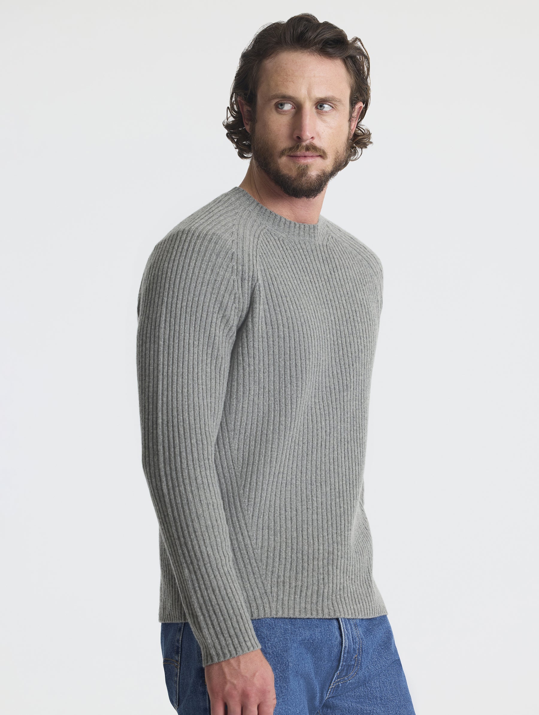 Angled view of man wearing Lyon Sweater in Heather Grey from AETHER Apparel. 