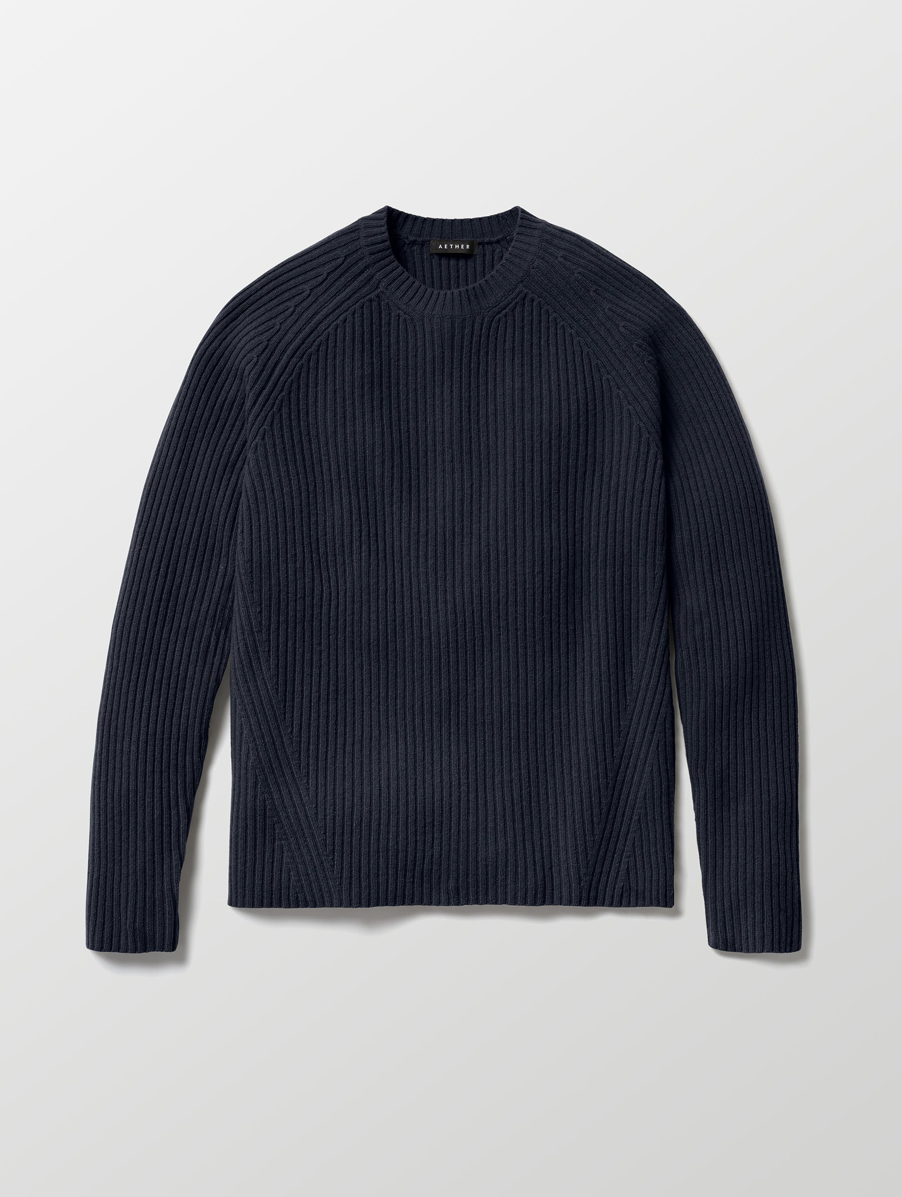 Flat lay of Lyon Sweater in Total Eclipse dark blue from AETHER Apparel. 