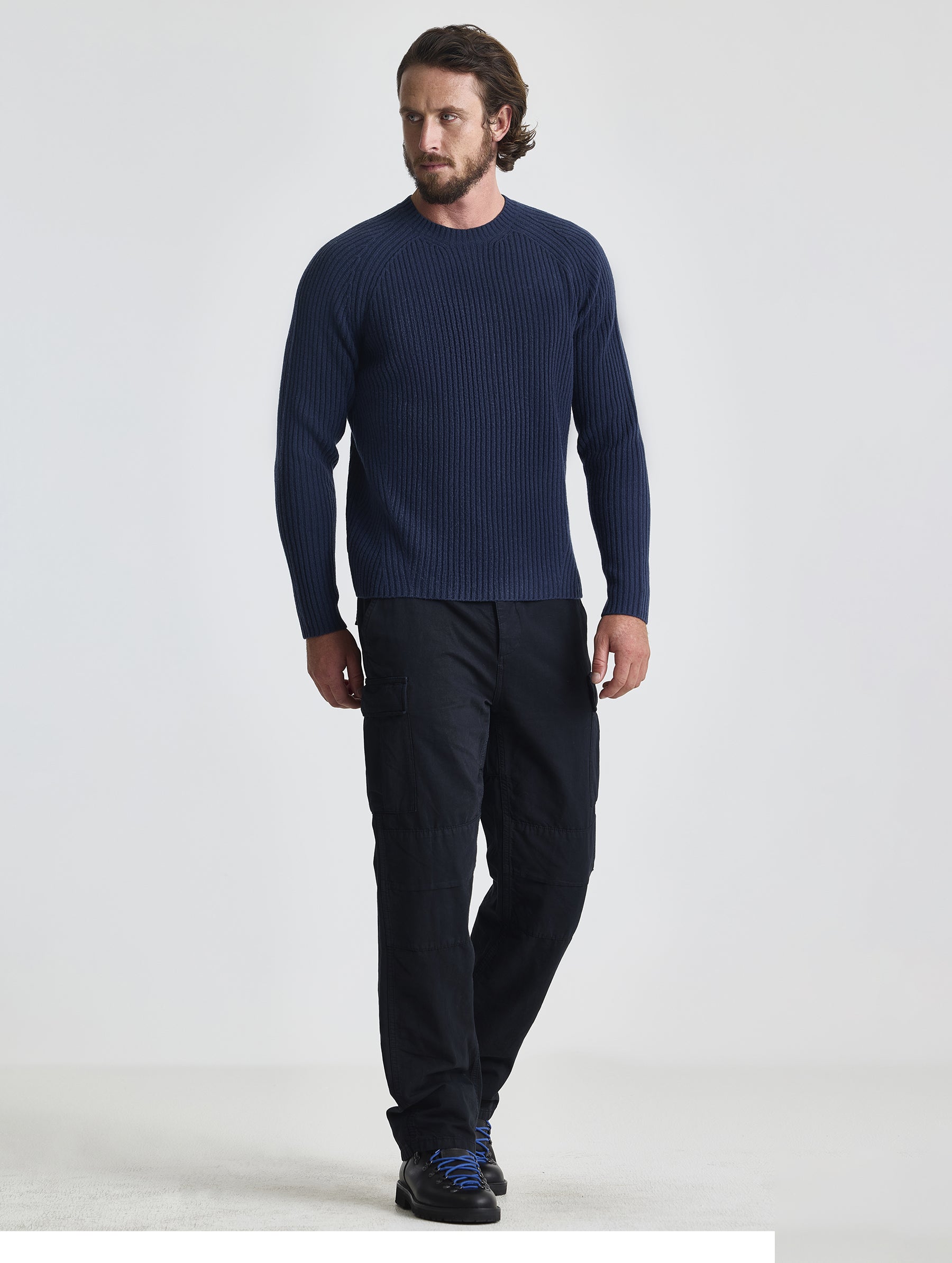 Full body view of man wearing Lyon Sweater in Total Eclipse dark blue from AETHER Apparel.