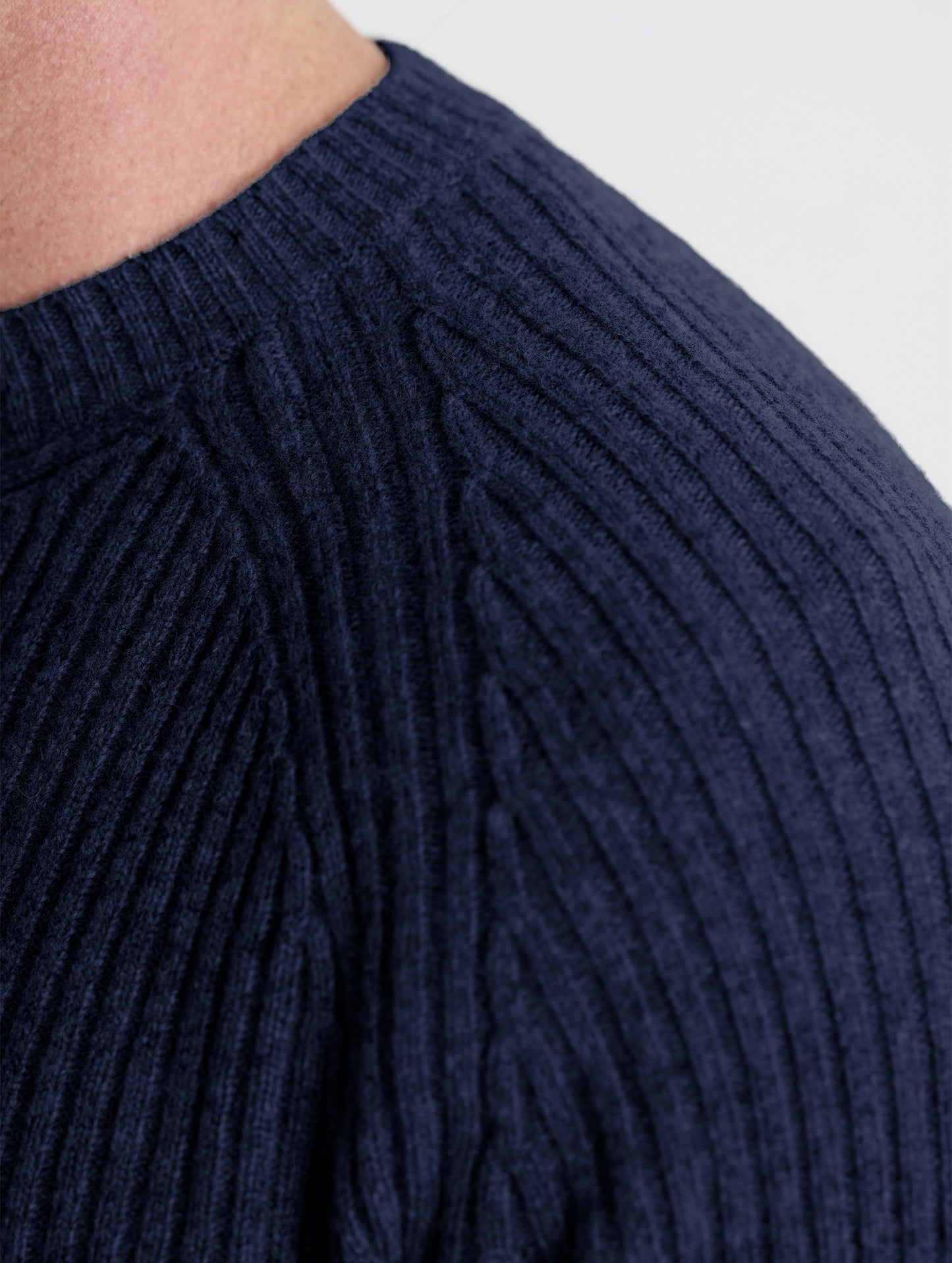 Closeup detail view of man's left shoulder of Lyon Sweater in Total Eclipse dark blue from AETHER Apparel.