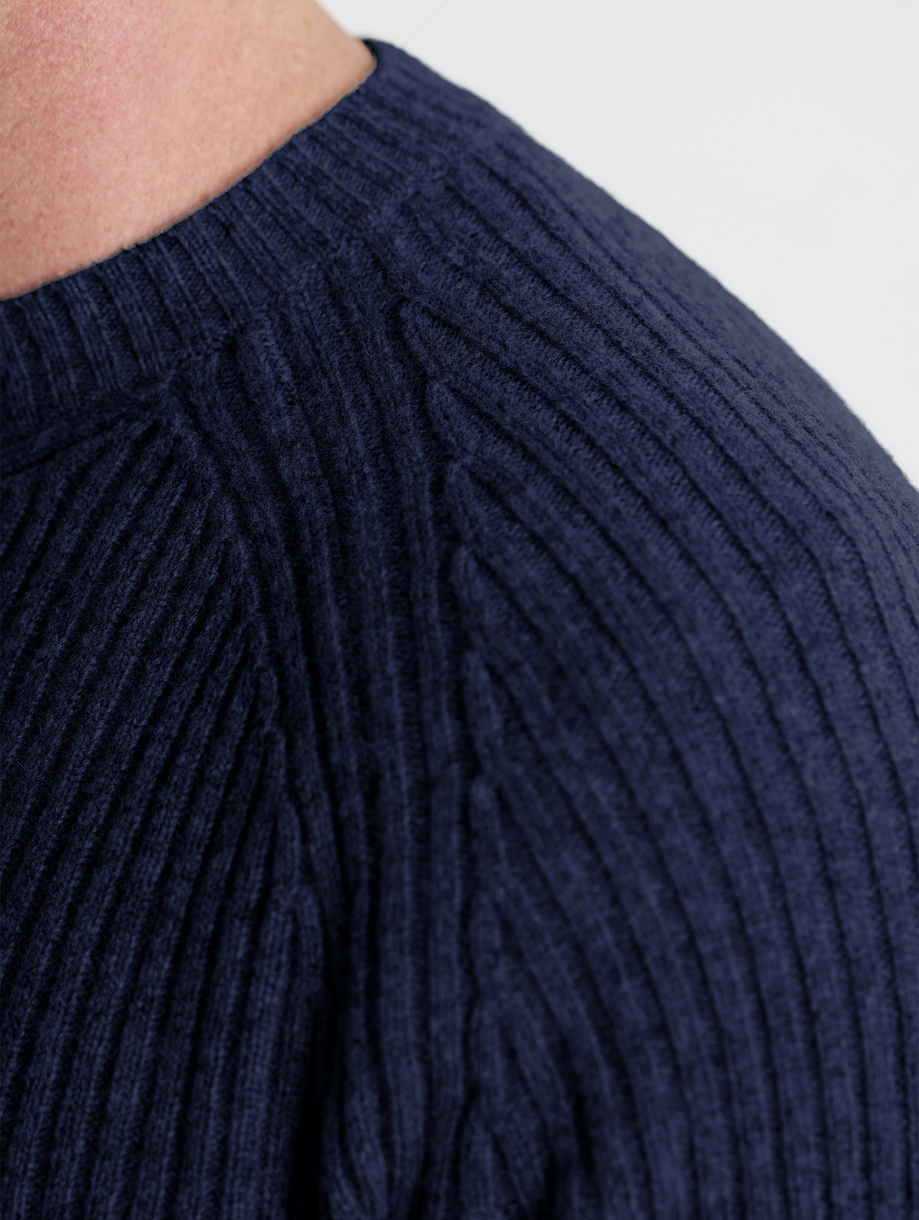 Closeup detail view of man's left shoulder of Lyon Sweater in Total Eclipse dark blue from AETHER Apparel.