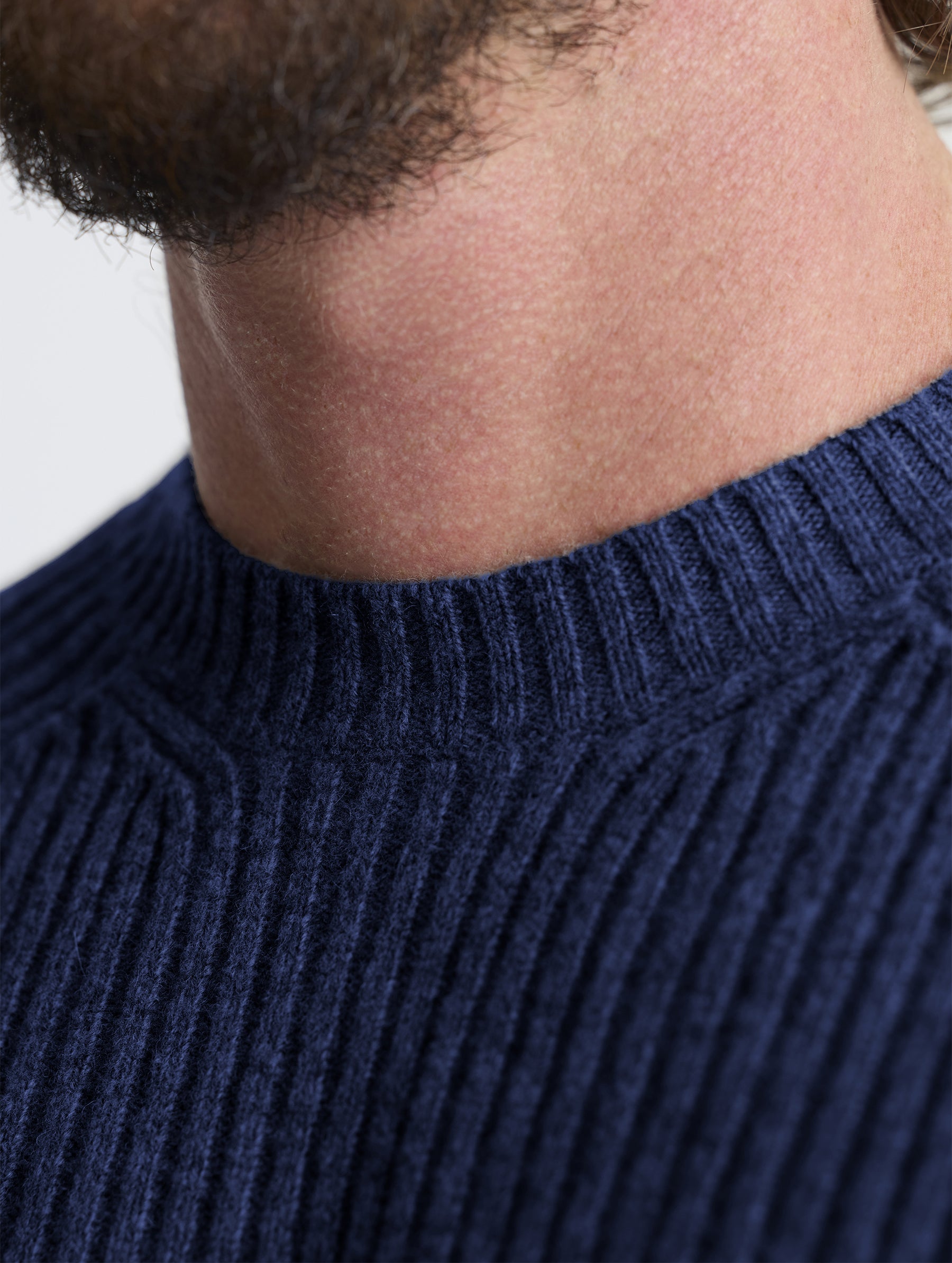 Closeup view of collar of Lyon Sweater in Total Eclipse dark blue from AETHER Apparel.