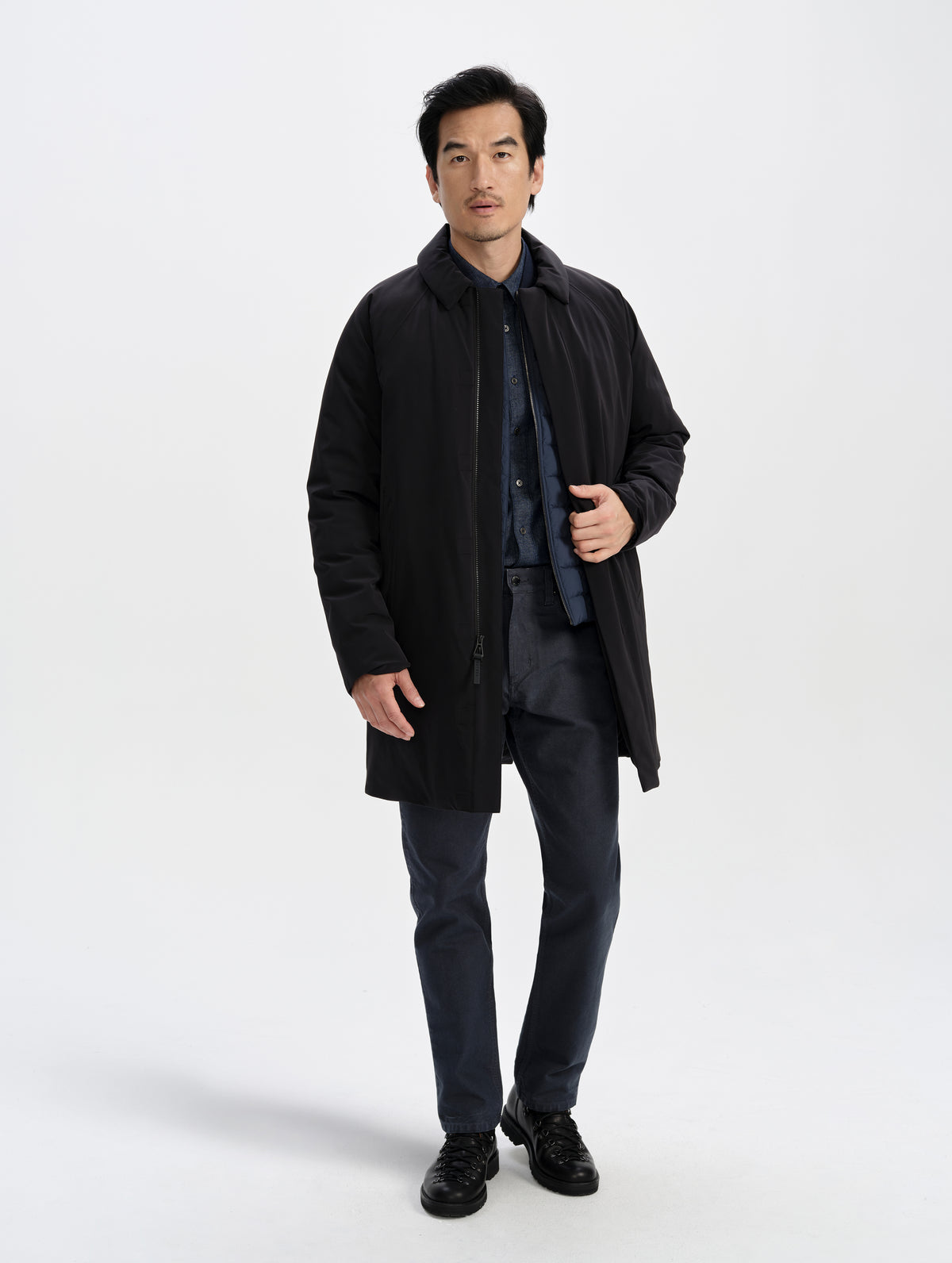 Front full-body view of man wearing the Maxwell Insulated Trench in Onyx Black from AETHER Apparel unzipped. 