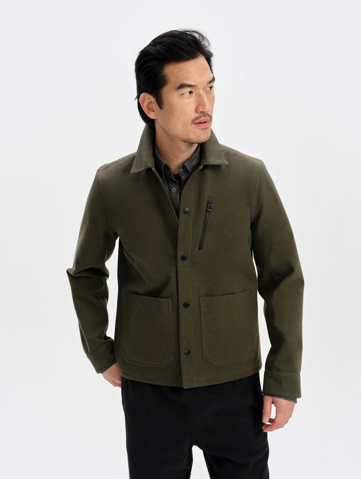 Front upper-body view of man wearing the Milton Chore Jacket in Forest Green from AETHER Apparel.