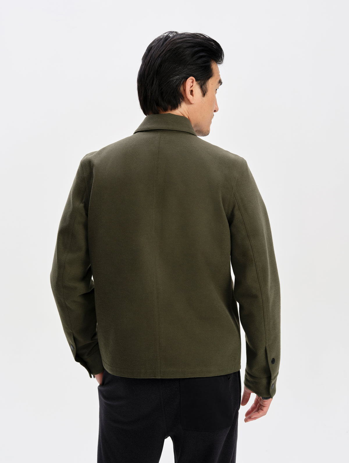 Rear upper-body view of man wearing the Milton Chore Jacket in Forest Green from AETHER Apparel.