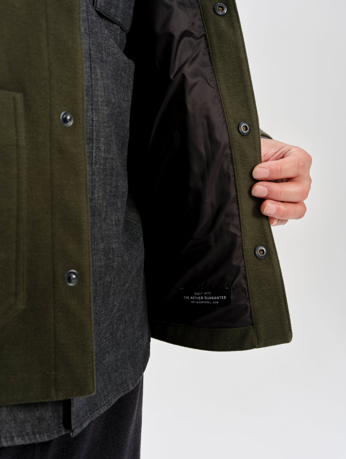 Closeup detailed view of the recycled micro ripstop liner on the Milton Chore Jacket in Forest Green from AETHER Apparel. 