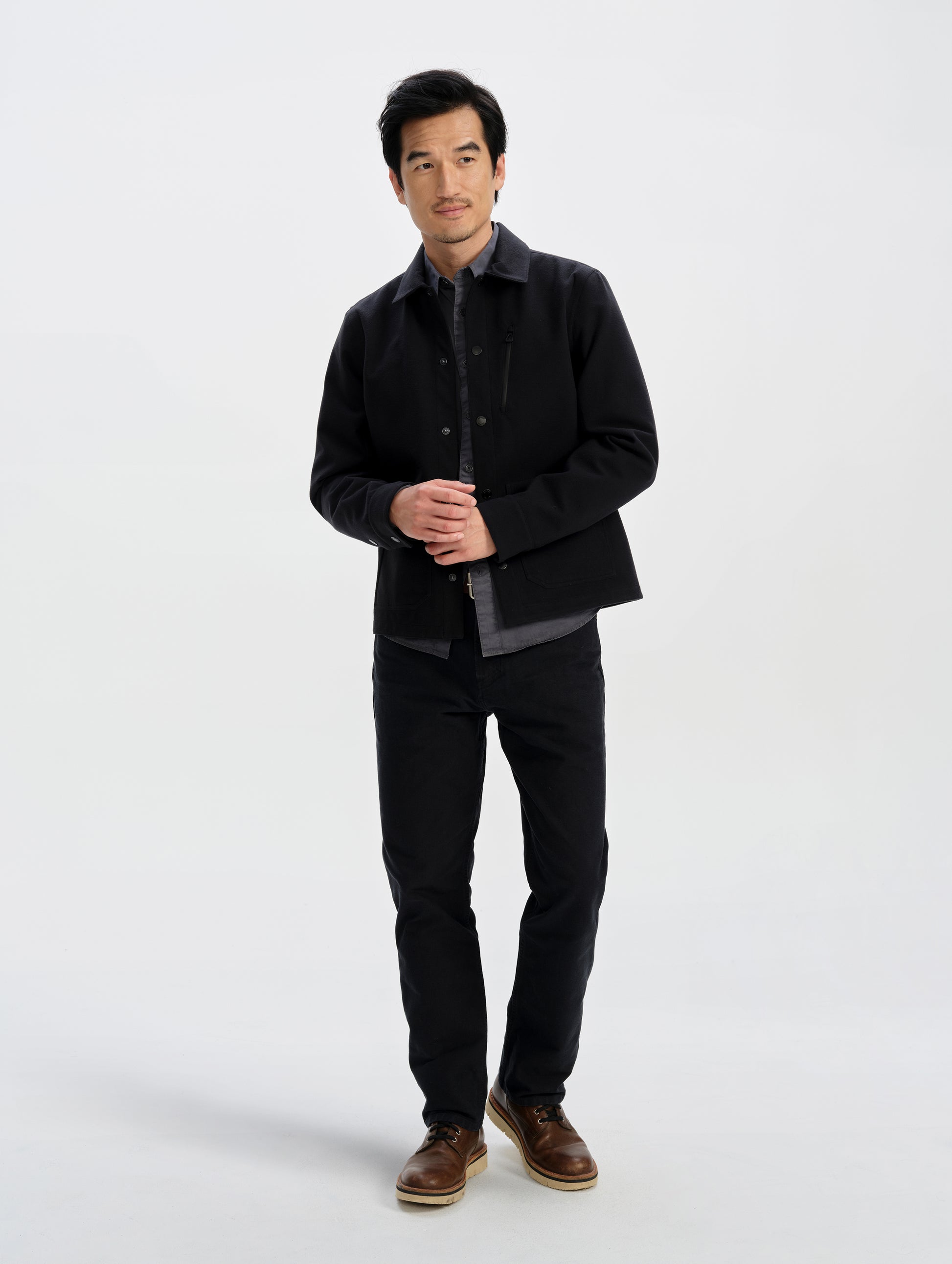 Front full-body view of man wearing the Milton Chore Jacket in Onyx Black from AETHER Apparel. 