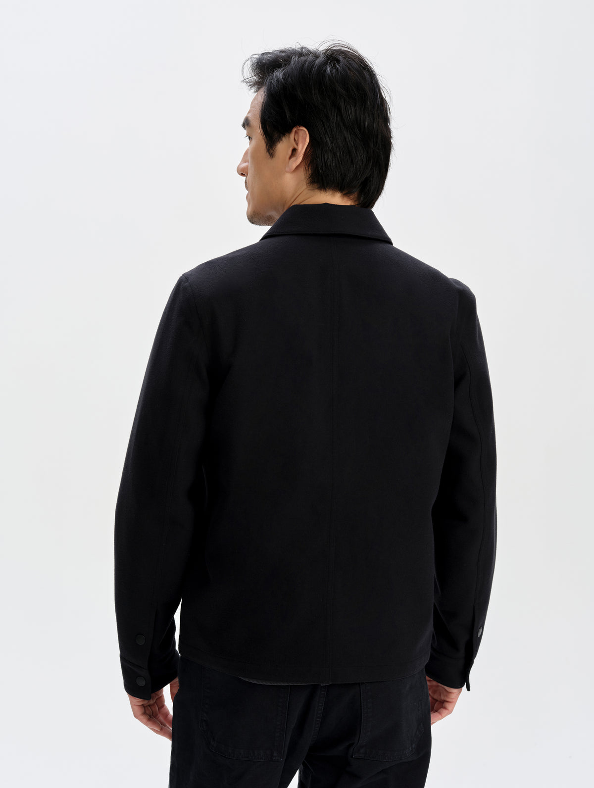 Front upper-body view of man wearing the Milton Chore Jacket in Onyx Black from AETHER Apparel. 