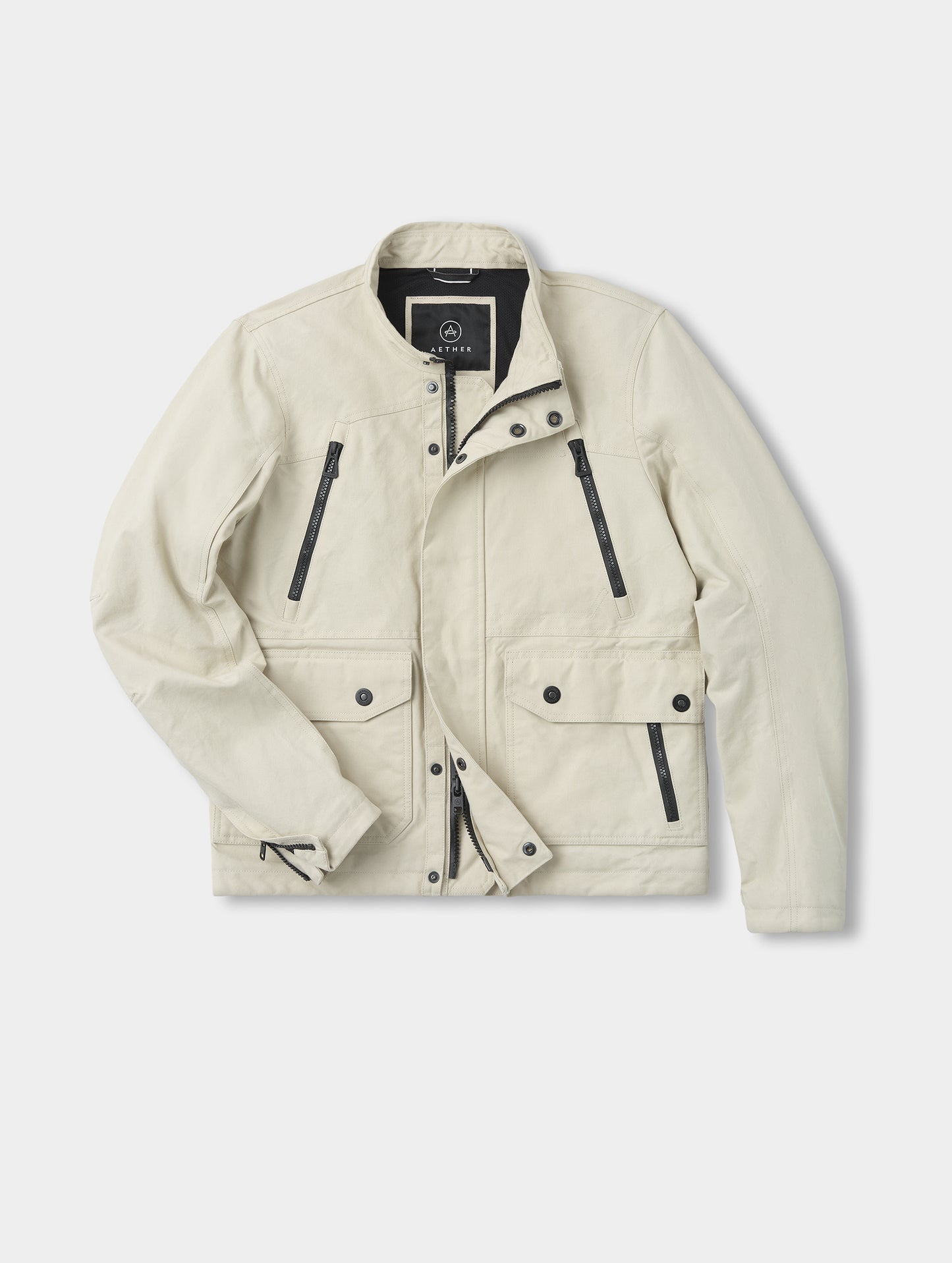 Flat lay view of the Mojave Motorcycle Jacket 2.0 in Bone from AETHER Apparel.