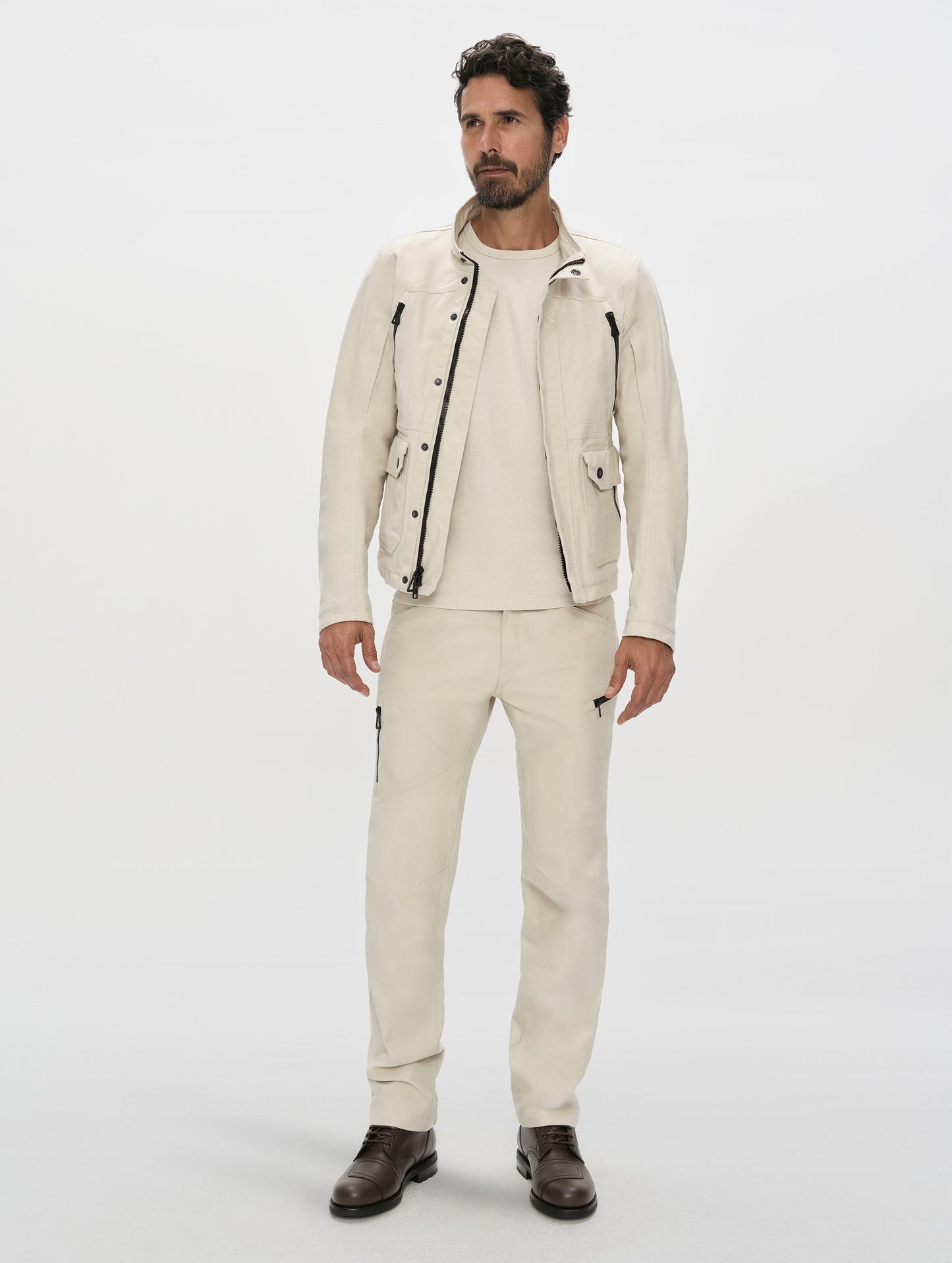 Front, full-body view of man wearing the Mojave Motorcycle Jacket 2.0 and Mojave Motorcycle Pant 2.0 in Bone from AETHER Apparel.