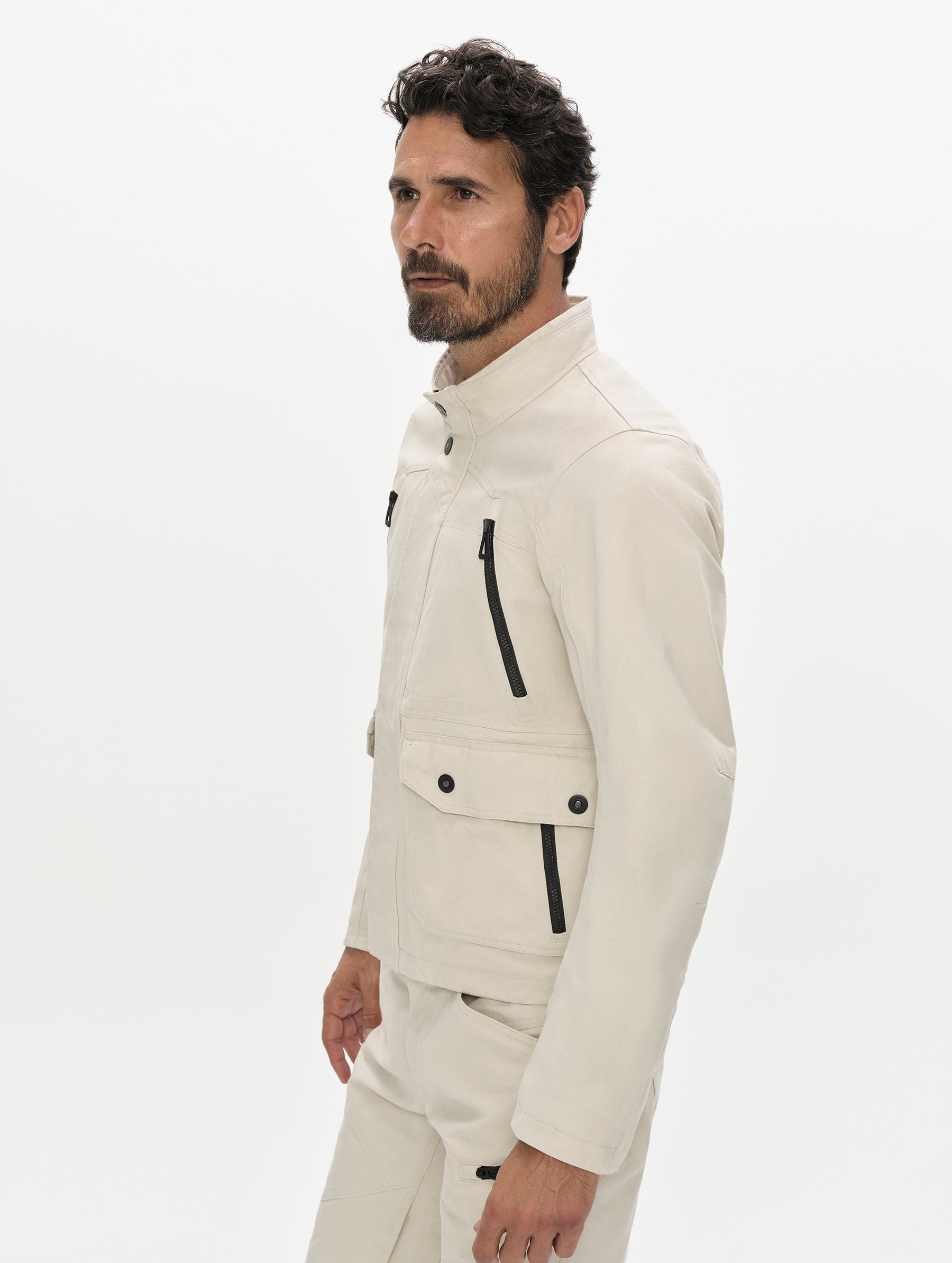 Front, 3/4, upper-body view of man wearing the Mojave Motorcycle Jacket 2.0 in Bone from AETHER Apparel.