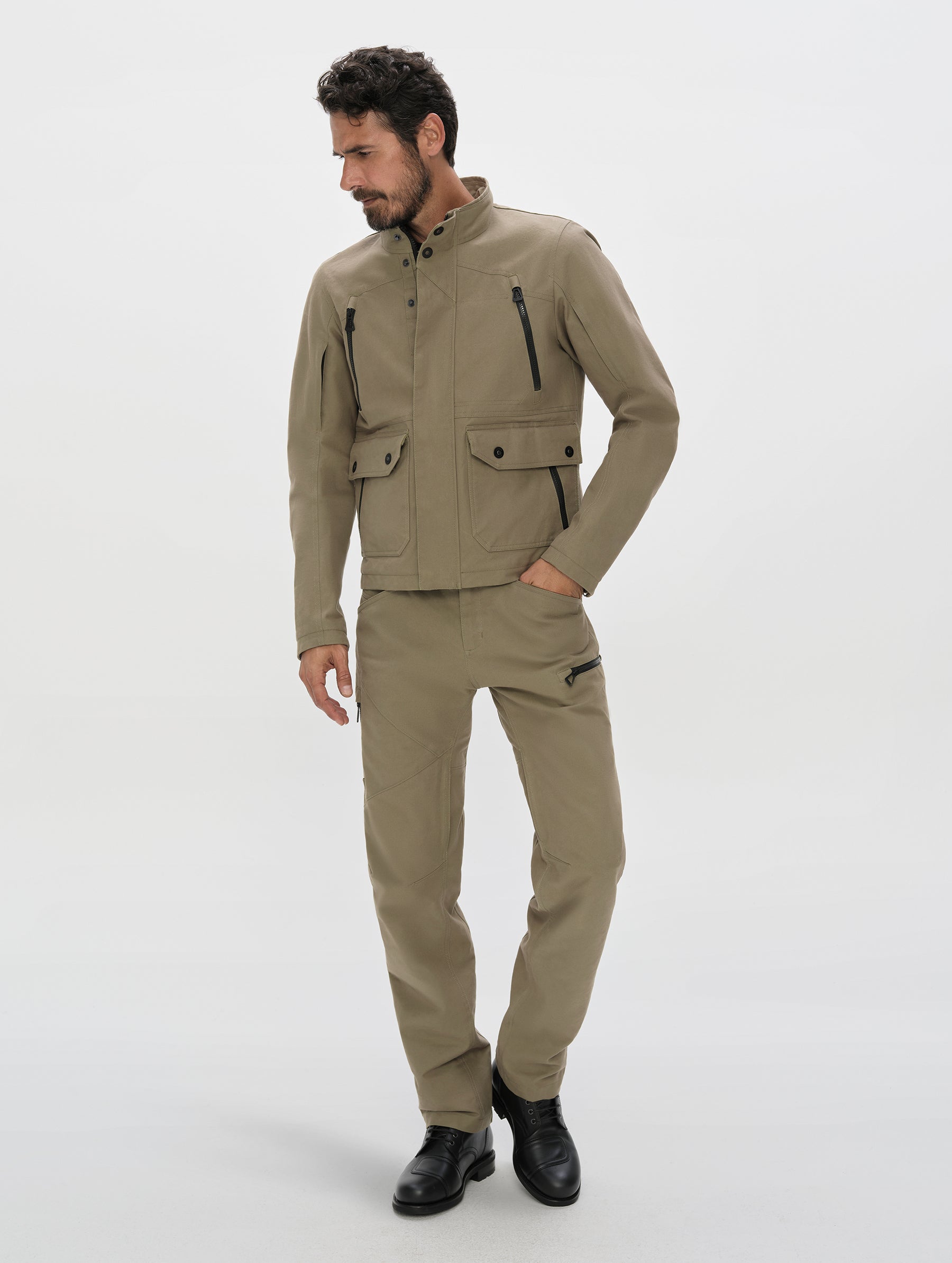 Front, full-body view of man wearing the Mojave Motorcycle Pant 2.0 and Mojave Motorcycle Jacket 2.0 in Stone Brown from AETHER Apparel.