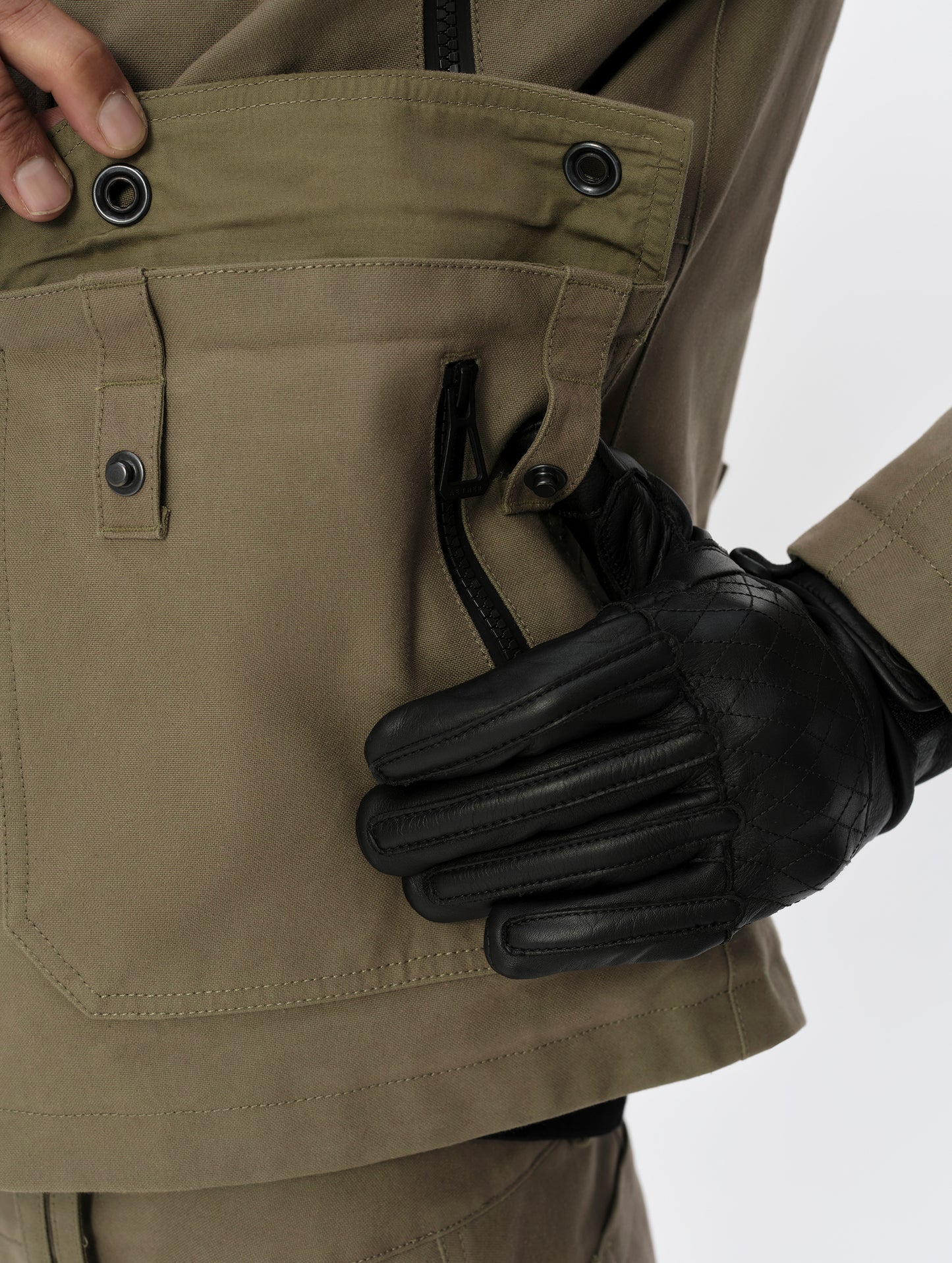 Closeup detailed view of the snap-secured patch pockets on the Mojave Motorcycle Jacket 2.0 in Stone Brown from AETHER Apparel.
