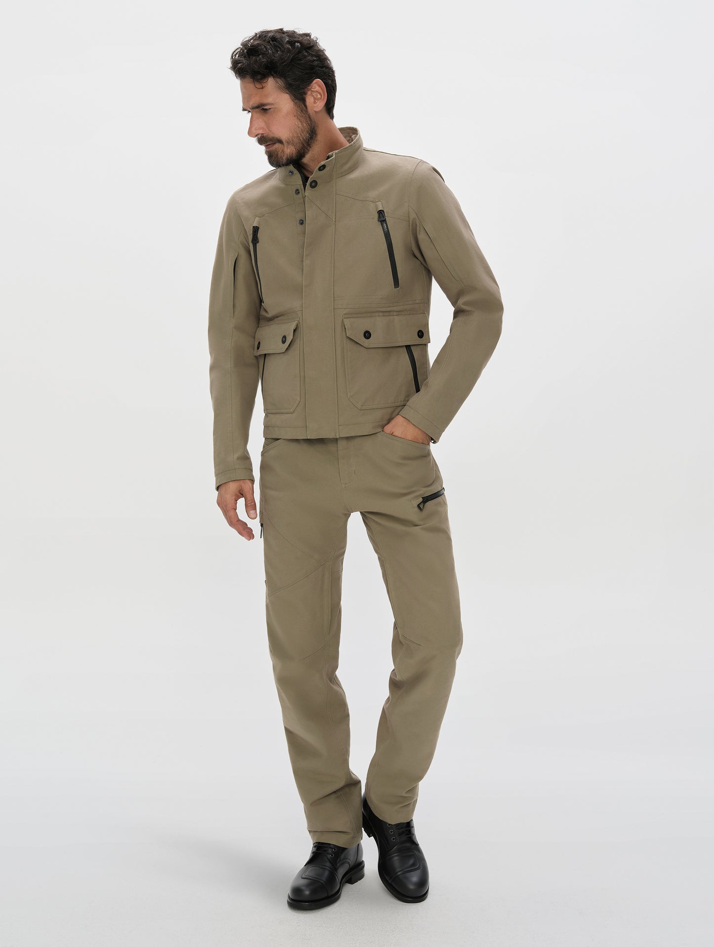 Front, full-body view of man wearing the Mojave Motorcycle Pant 2.0 and Mojave Motorcycle Jacket 2.0 in Stone Brown from AETHER Apparel.