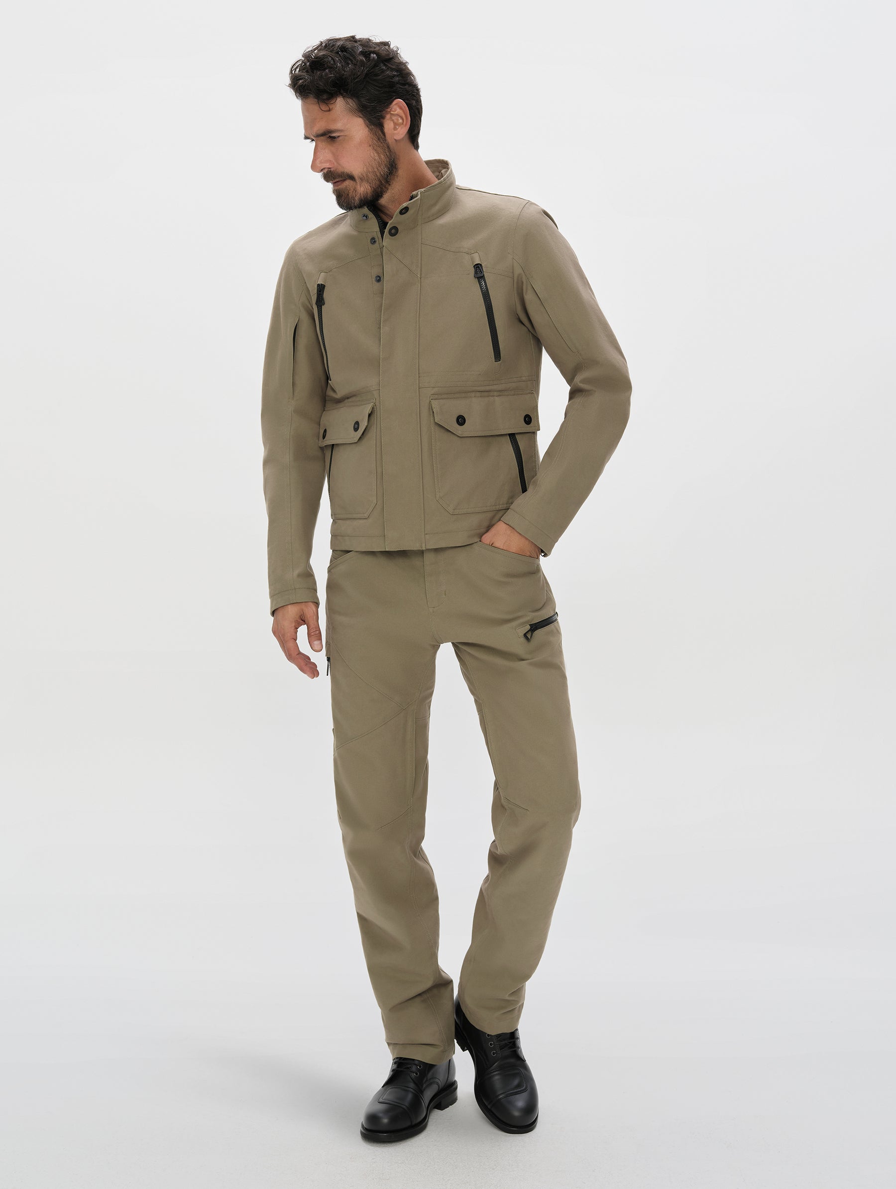 Front, full-body view of man wearing the Mojave Motorcycle Pant 2.0 and Mojave Motorcycle Jacket 2.0 in Stone Brown from AETHER Apparel.