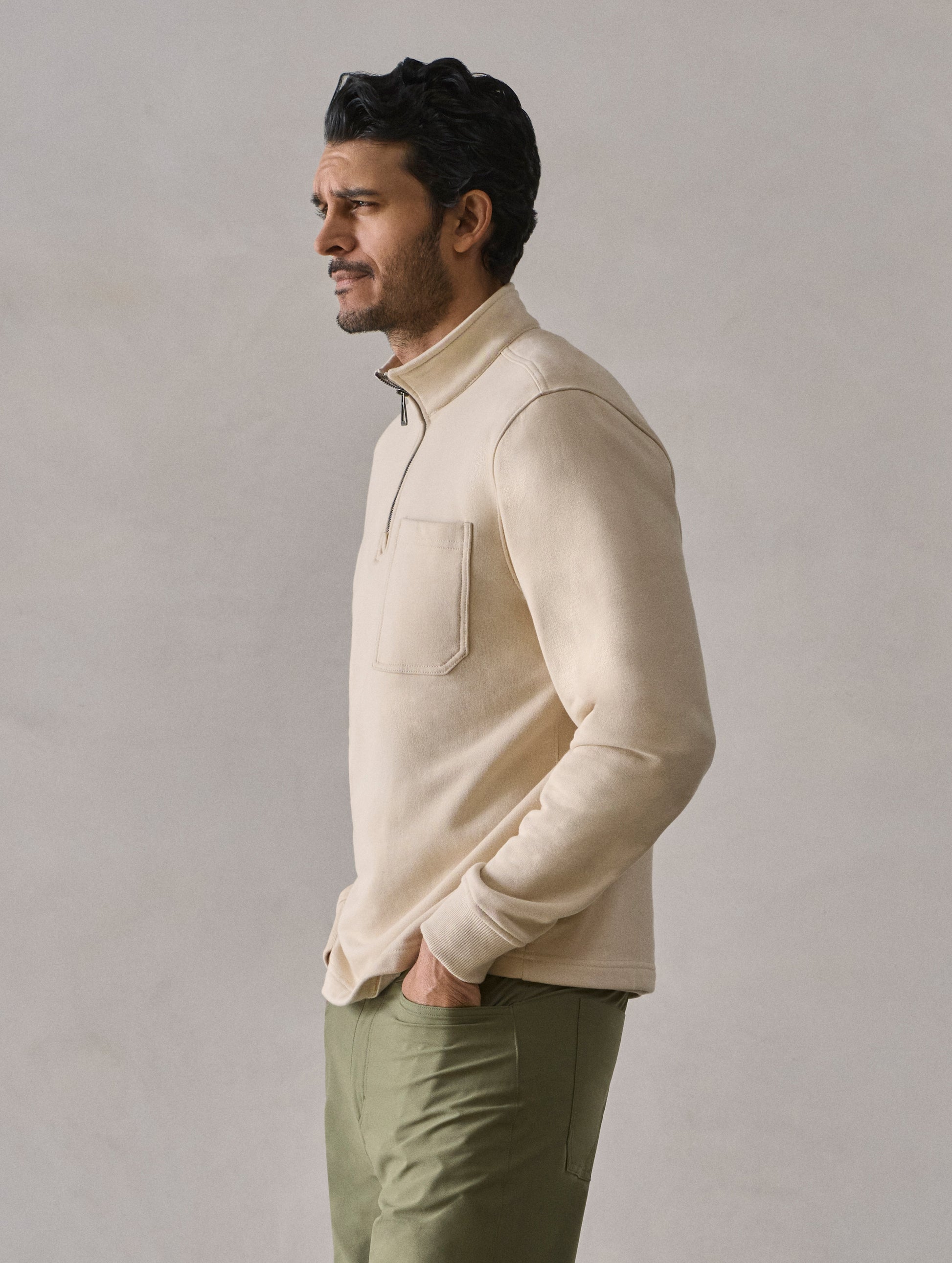 Side profile view of man wearing Monte Half-Zip Sweatshirt in Bone white from AETHER Apparel.