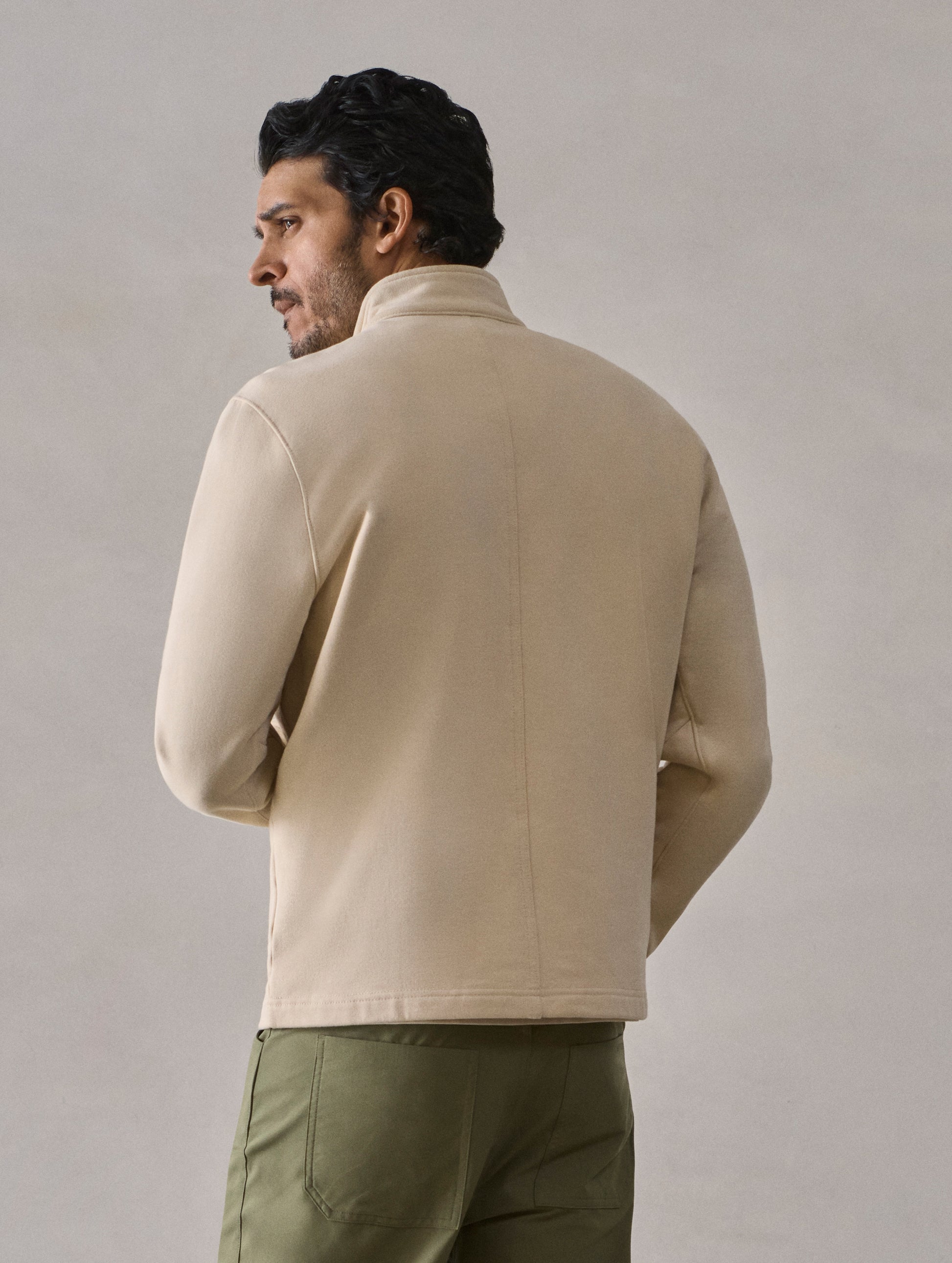 Rear view of man wearing Monte Half-Zip Sweatshirt in Bone white from AETHER Apparel.