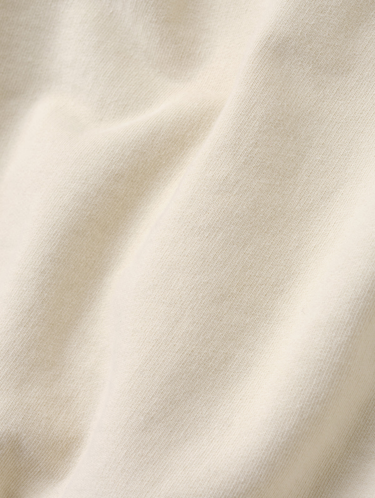 Closeup detailed view of the fleece cotton fabric on the Monte Jersey Hoodie 2.0 in Bone from AETHER Apparel. 