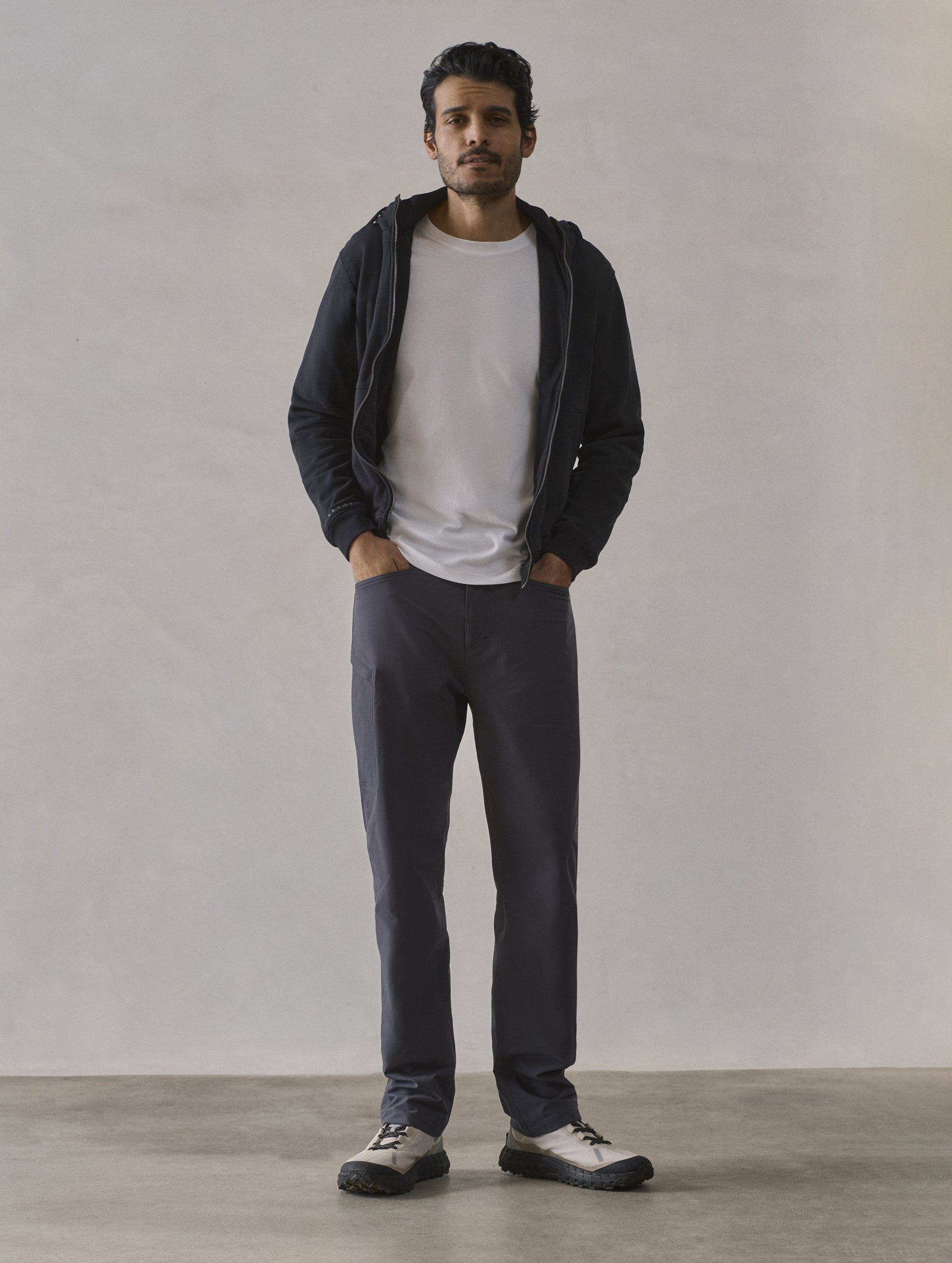 Front full-body view of man wearing Monte Full-Zip Hoodie in Onyx Black from AETHER Apparel.