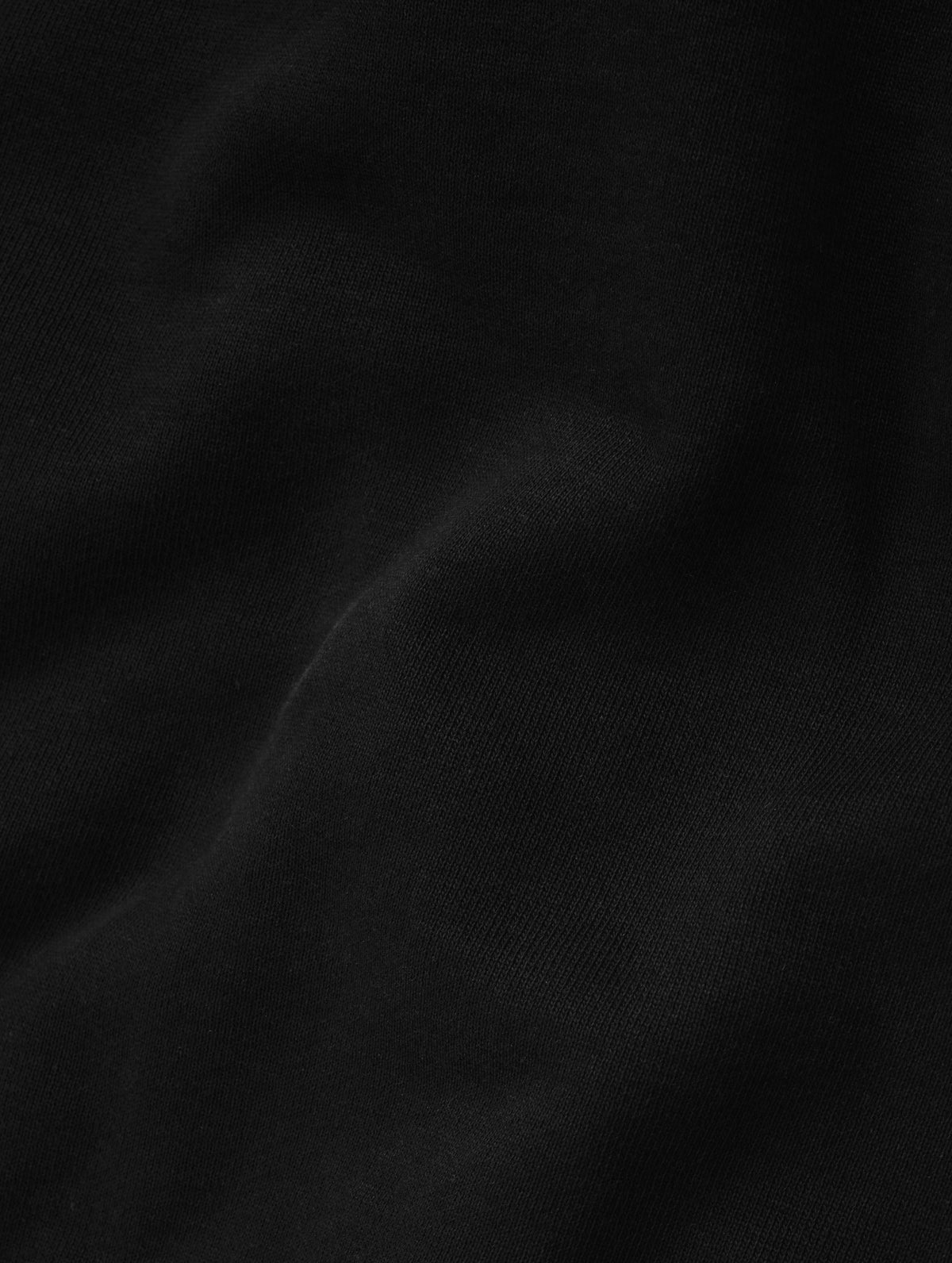 Closeup detailed view of the fleece cotton fabric on the Monte Jersey Hoodie 2.0 in Onyx Black from AETHER Apparel. 