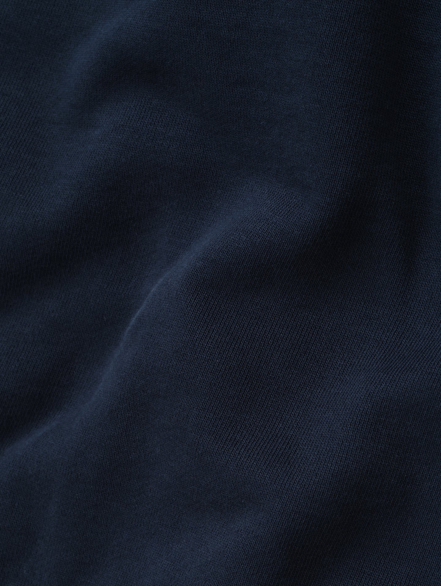 Closeup detailed view of the fleece cotton fabric on the Monte Jersey Hoodie 2.0 in Total Eclipse from AETHER Apparel. 