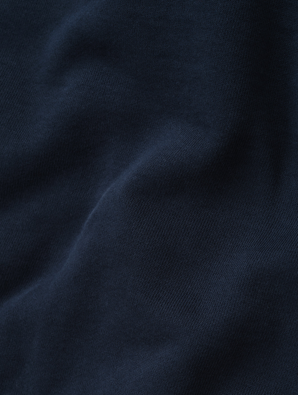 Closeup detailed view of the fleece cotton fabric on the Monte Jersey Hoodie 2.0 in Total Eclipse from AETHER Apparel. 