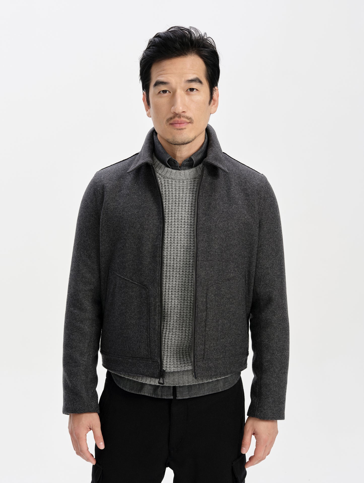 Front upper-body view of man wearing the Monza Wool Jacket 2.0 in Charcoal Grey from AETHER Apparel.
