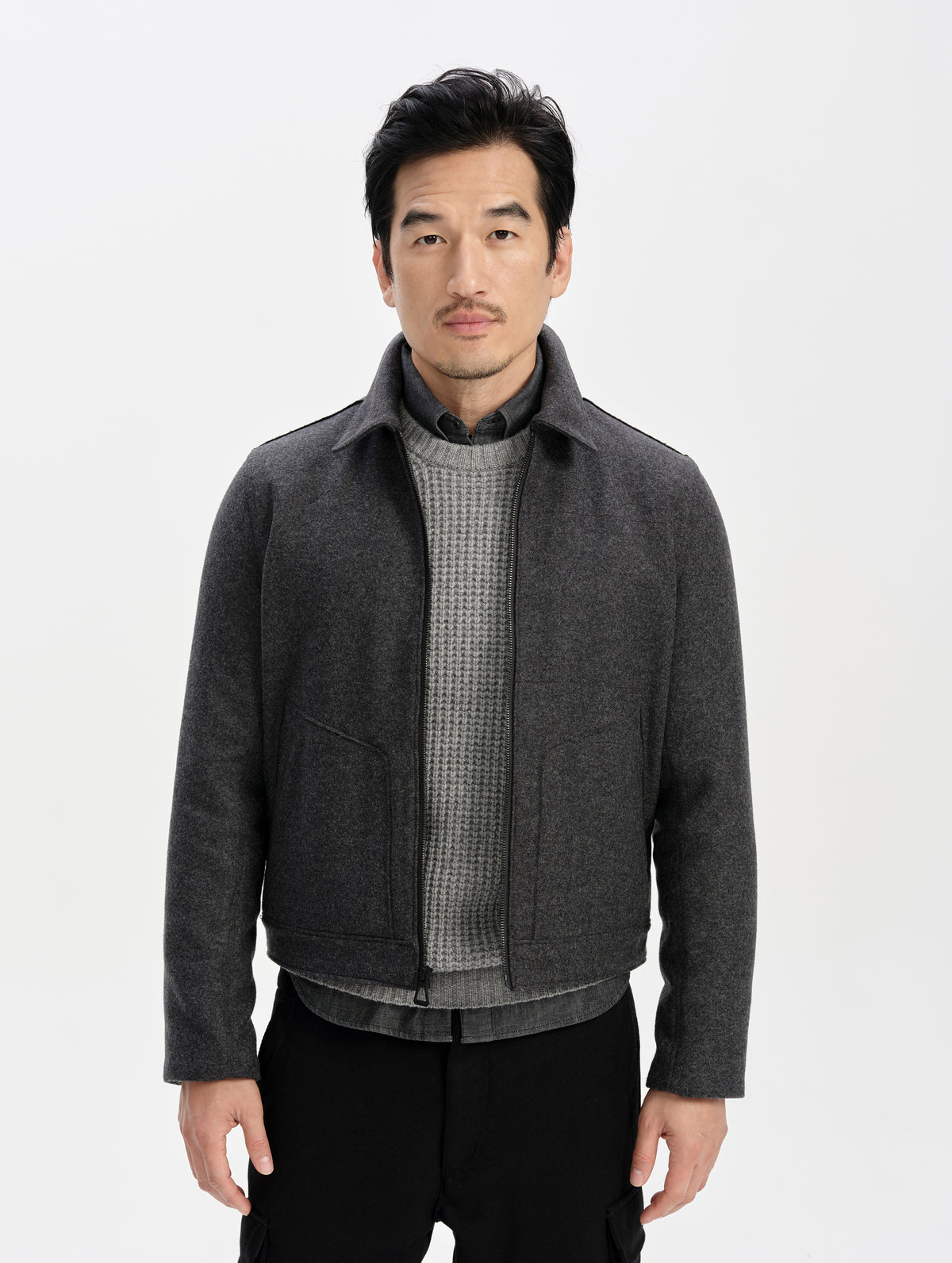 Front upper-body view of man wearing the Monza Wool Jacket 2.0 in Charcoal Grey from AETHER Apparel.
