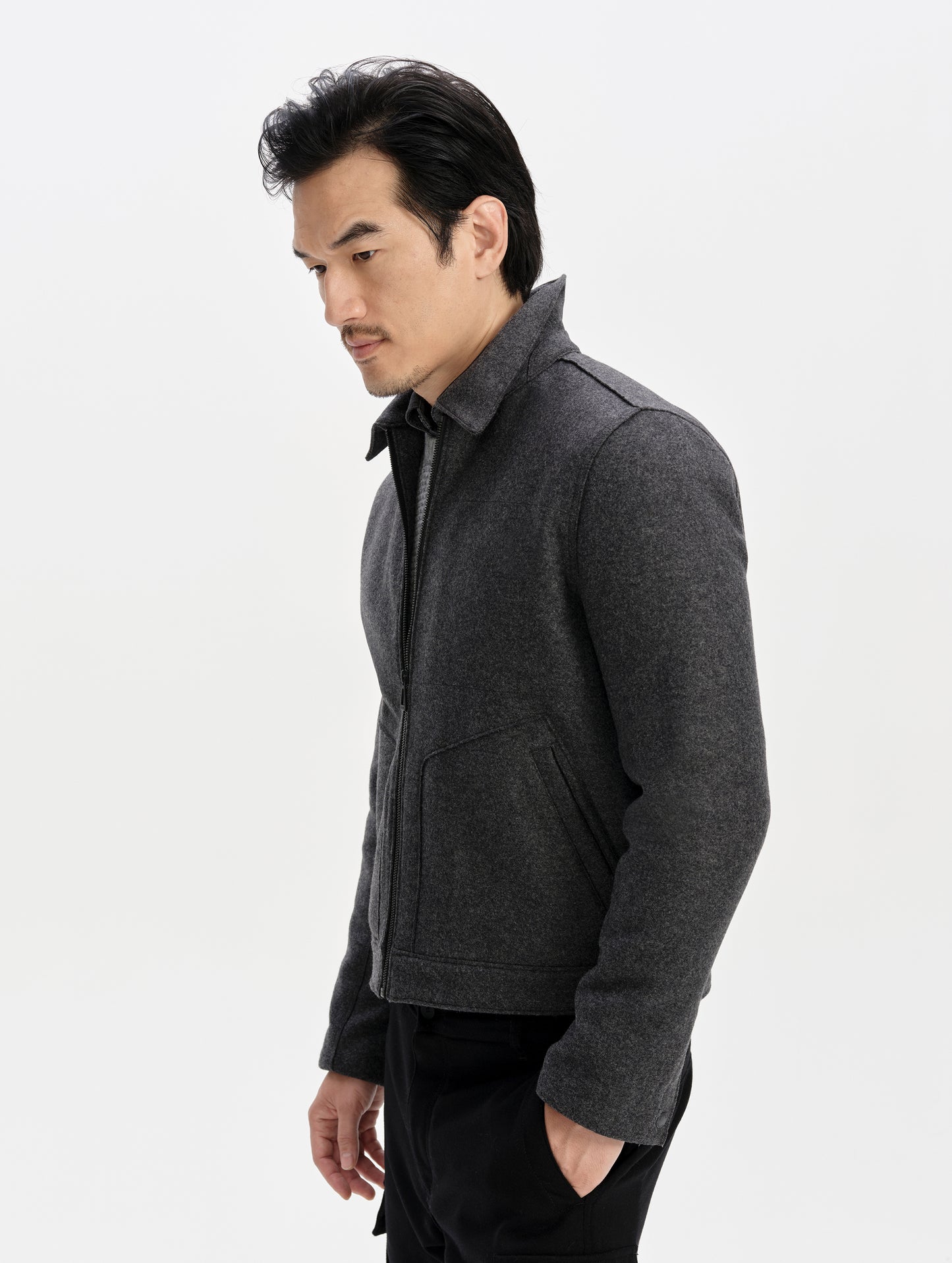 Side profile upper-body view of man wearing the Monza Wool Jacket 2.0 in Charcoal Grey from AETHER Apparel.