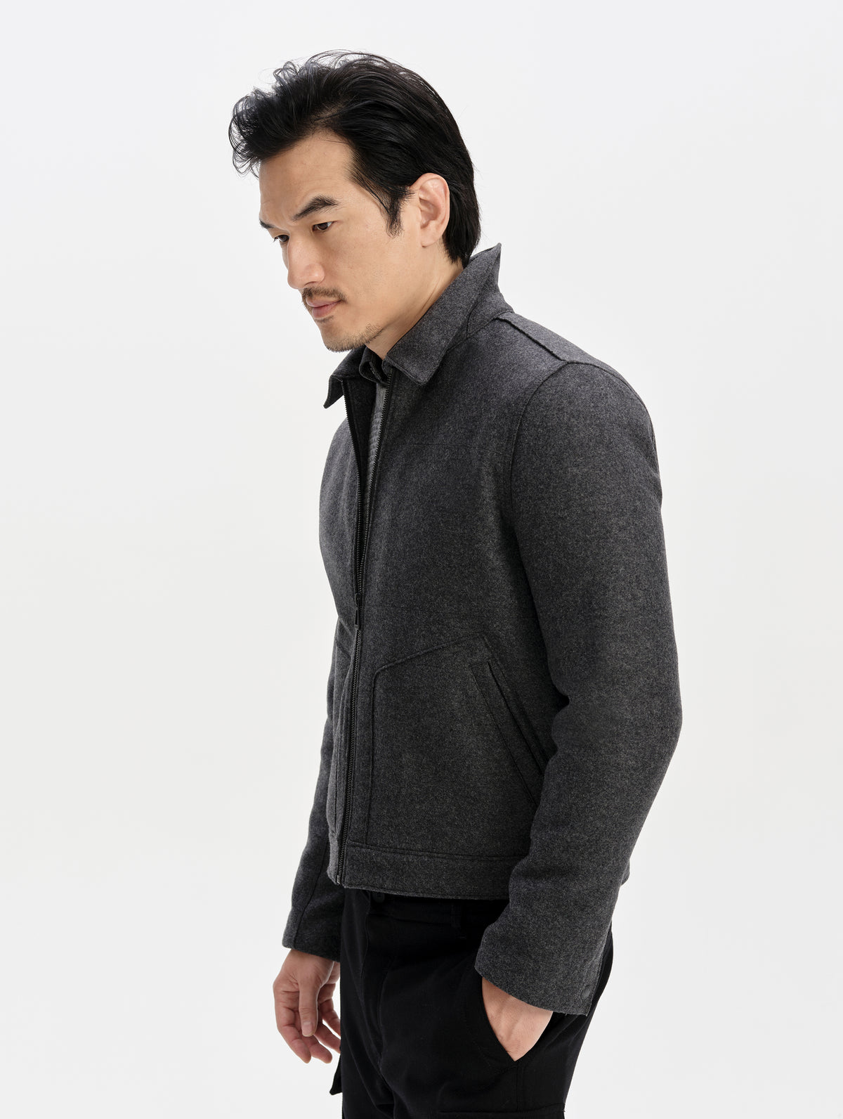 Side profile upper-body view of man wearing the Monza Wool Jacket 2.0 in Charcoal Grey from AETHER Apparel.