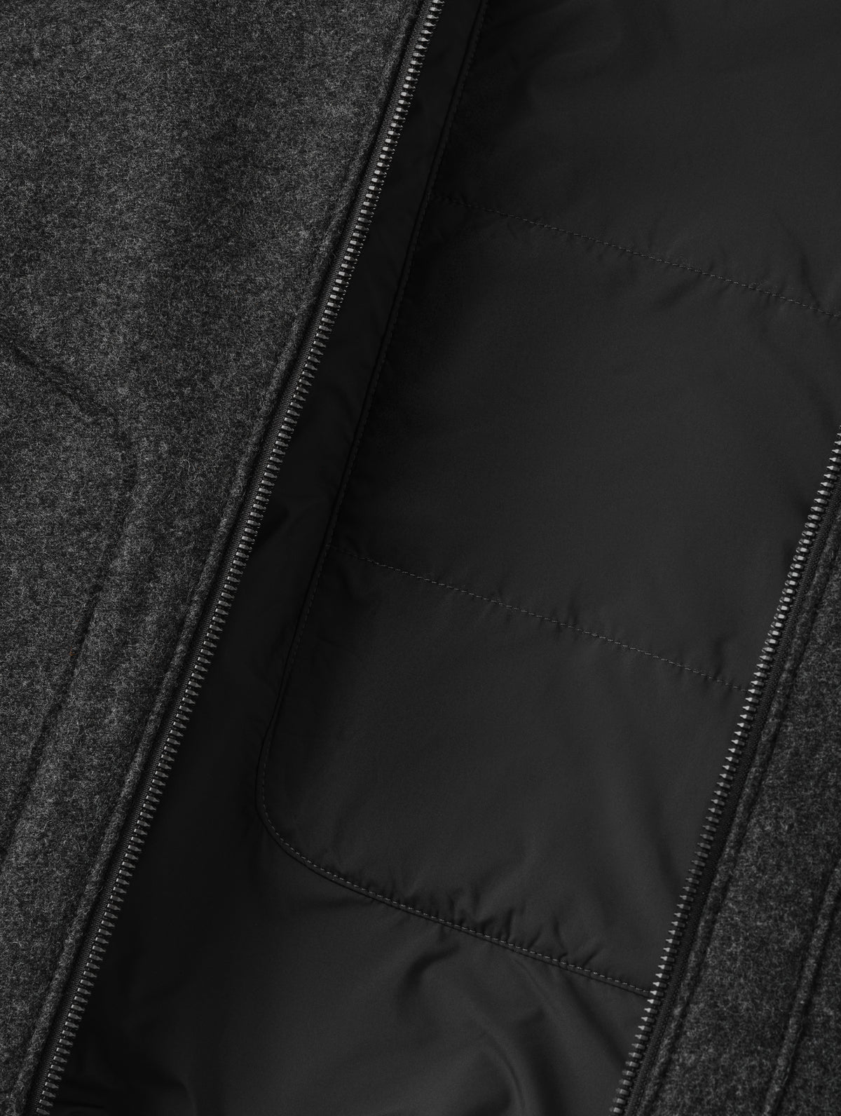 Closeup detailed view of the Primaloft Gold-insulated, quilted back panel and lightweight taffeta lining on the Monza Wool Jacket 2.0 in Charcoal Grey from AETHER Apparel.