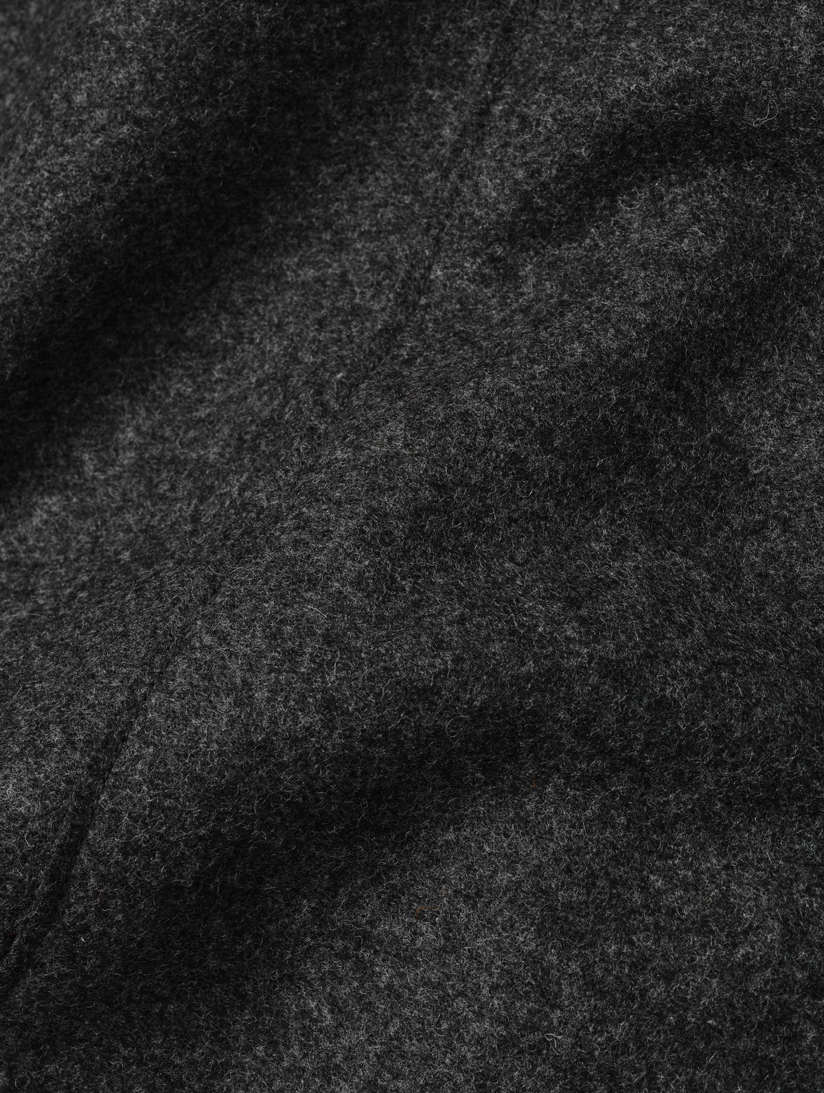 Closeup detailed view of the recycled wool blend fabric construction on the Monza Wool Jacket 2.0 in Charcoal Grey from AETHER Apparel.