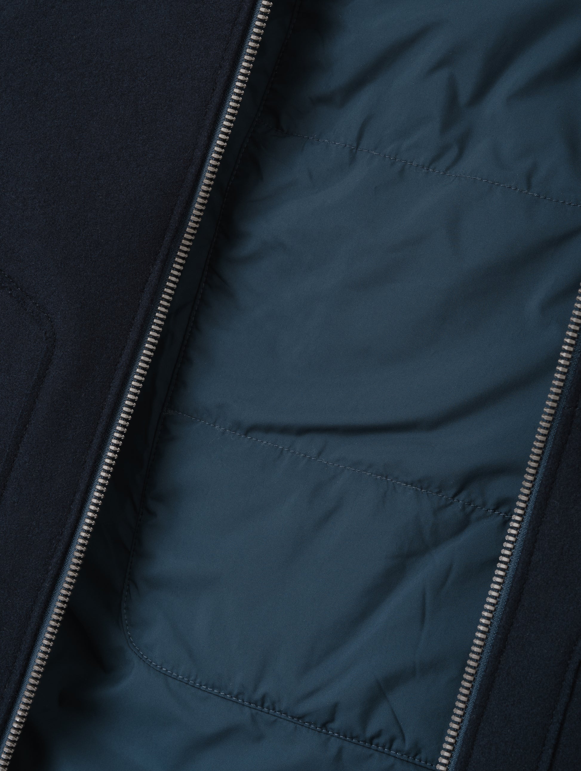 Closeup detailed view of the Primaloft Gold-insulated, quilted back panel and lightweight taffeta lining on the Monza Wool Jacket 2.0 in Total Eclipse from AETHER Apparel.