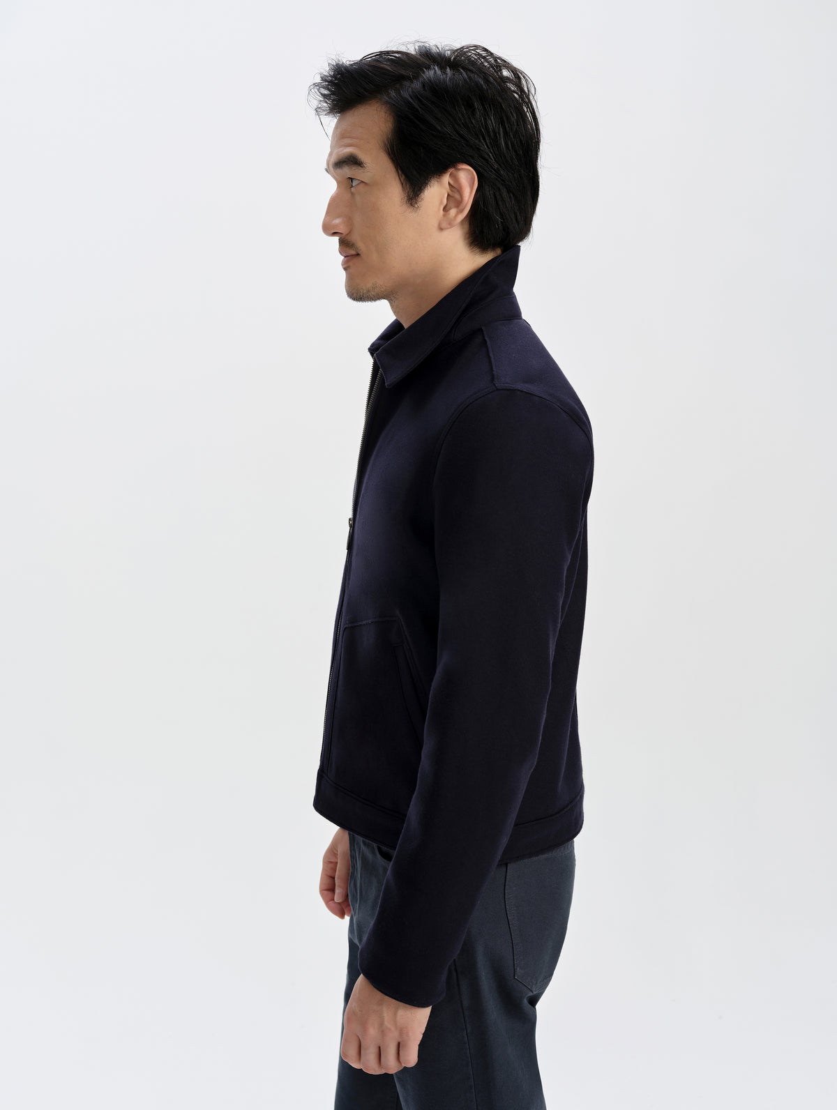 Side profile upper-body view of man wearing the Monza Wool Jacket 2.0 in Total Eclipse from AETHER Apparel.