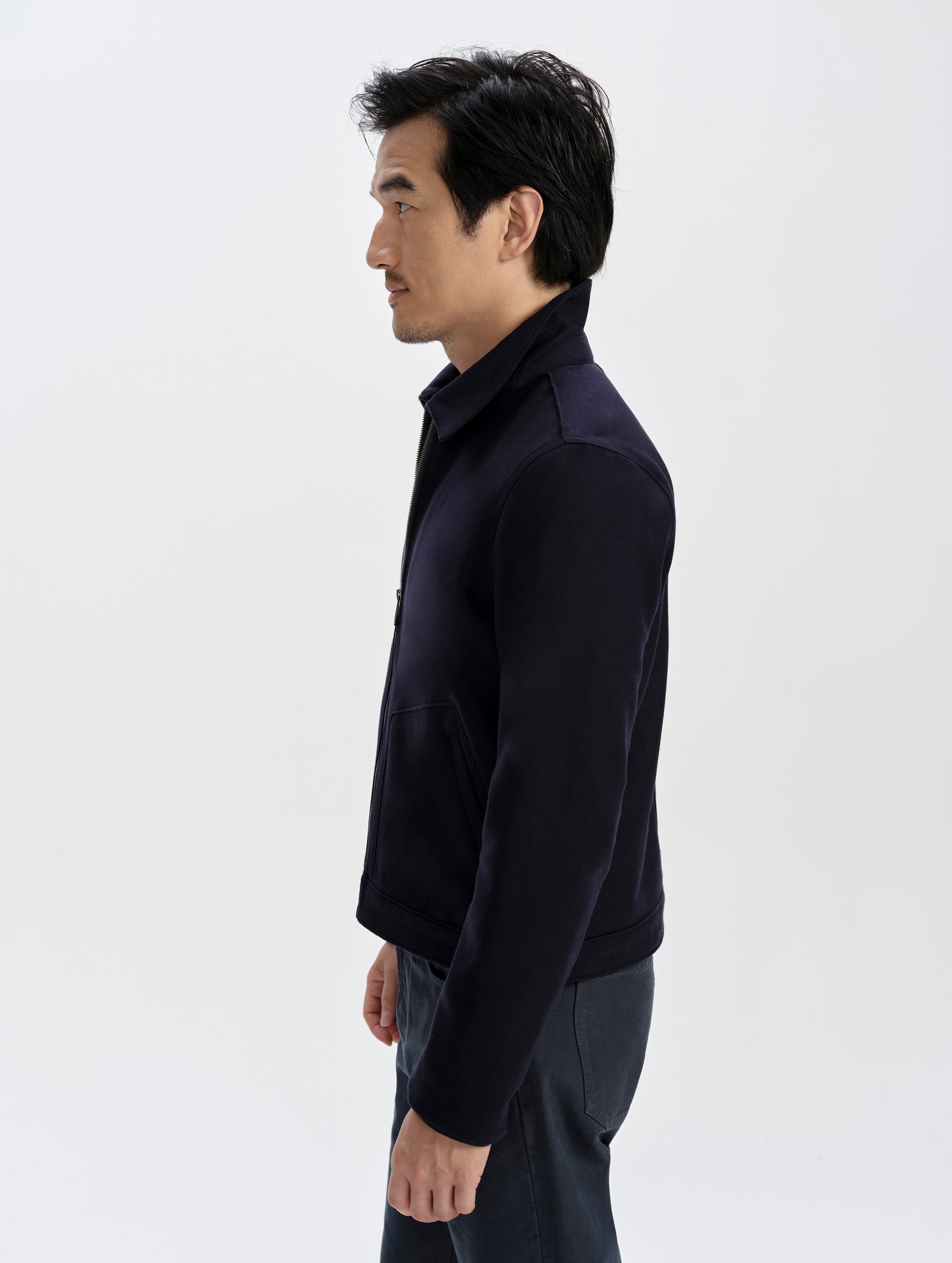 Side profile upper-body view of man wearing the Monza Wool Jacket 2.0 in Total Eclipse from AETHER Apparel.