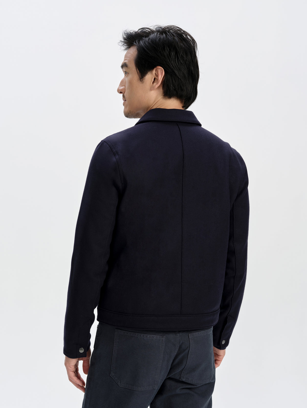 Rear upper-body view of man wearing the Monza Wool Jacket 2.0 in Total Eclipse from AETHER Apparel.