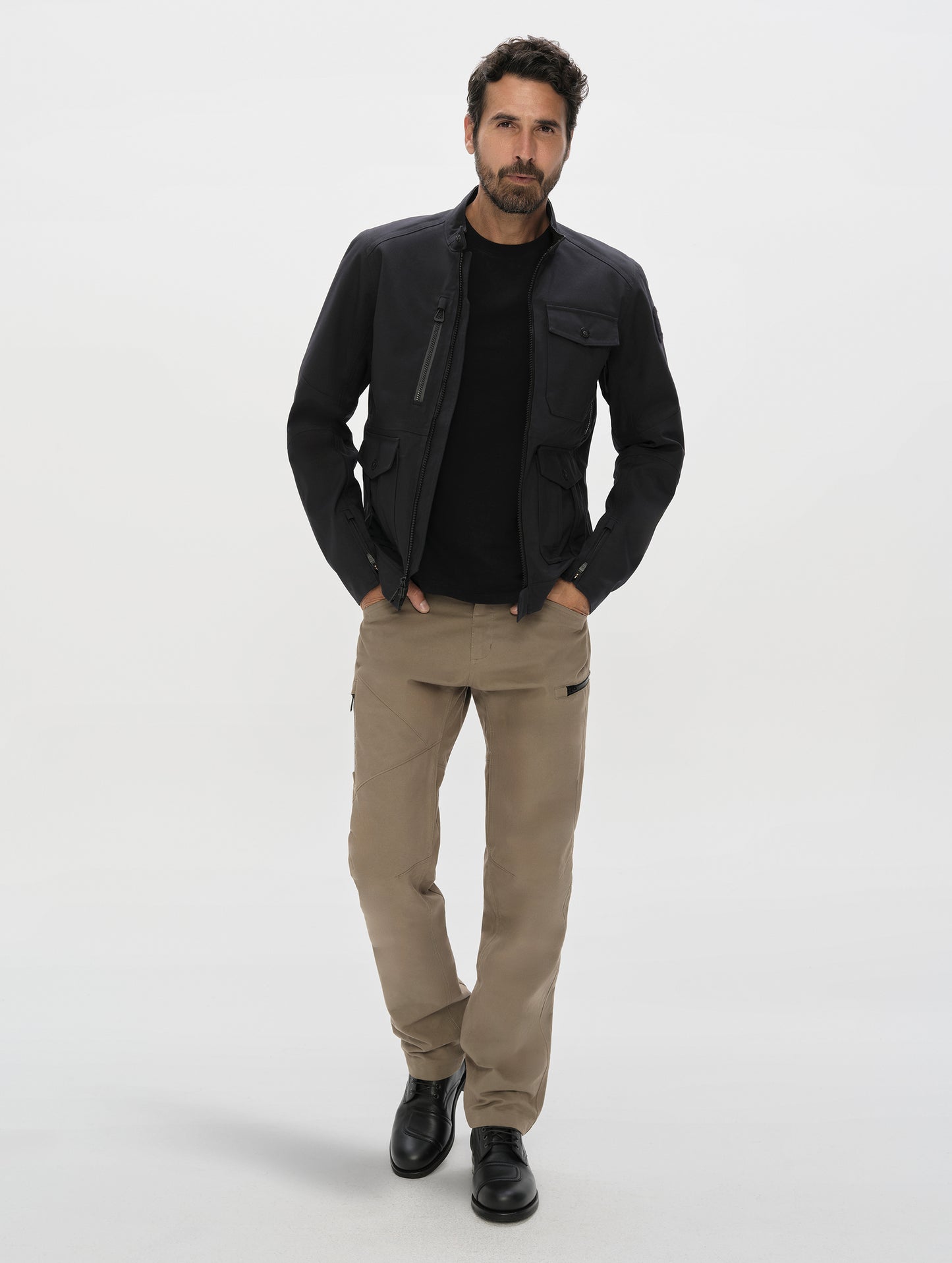 Front, full-body view of man wearing the Mulholland Motorcycle Jacket Special Edition in Onyx Black from AETHER Apparel.