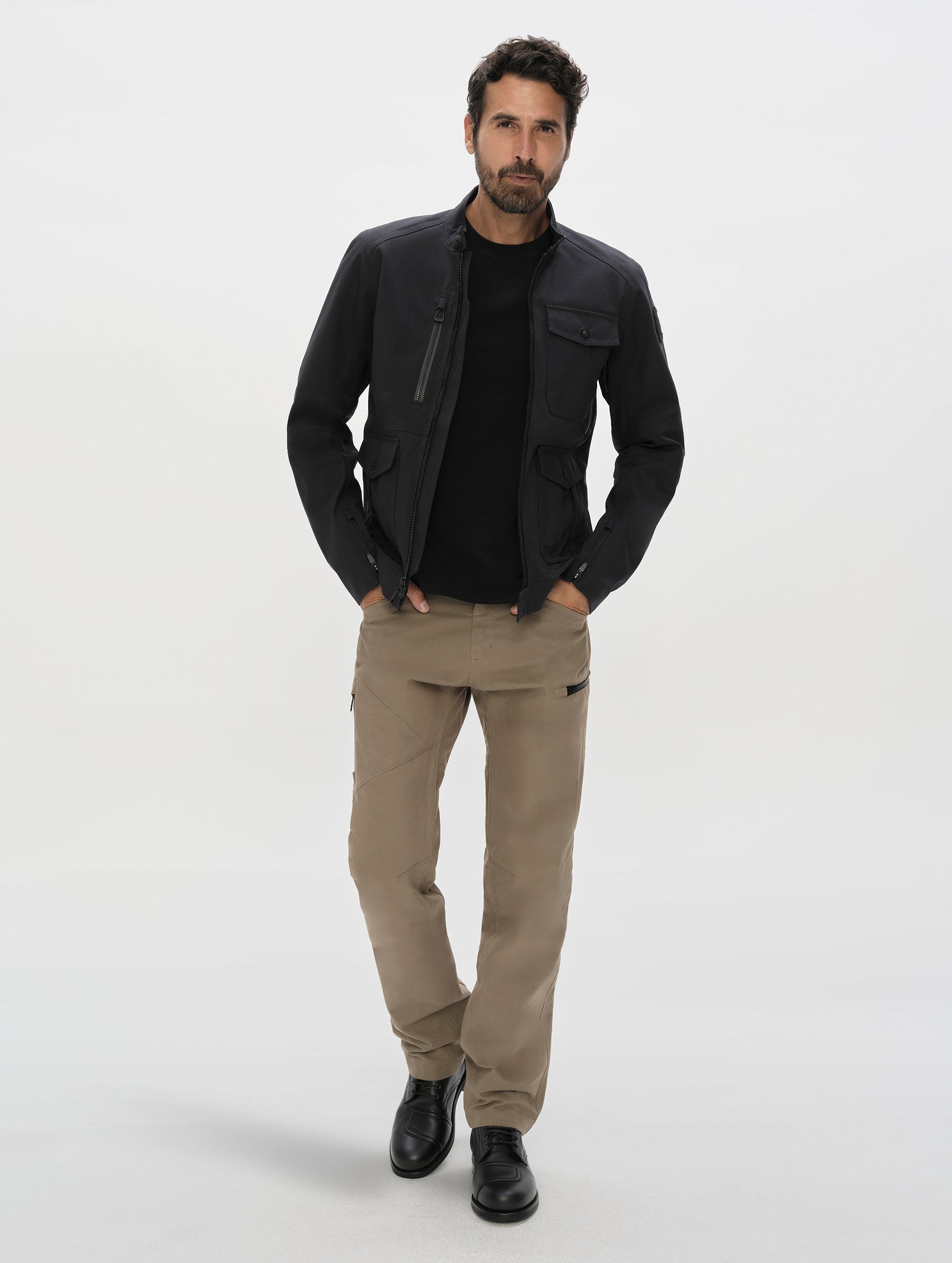 Front, full-body view of man wearing the Mulholland Motorcycle Jacket Special Edition in Onyx Black from AETHER Apparel.