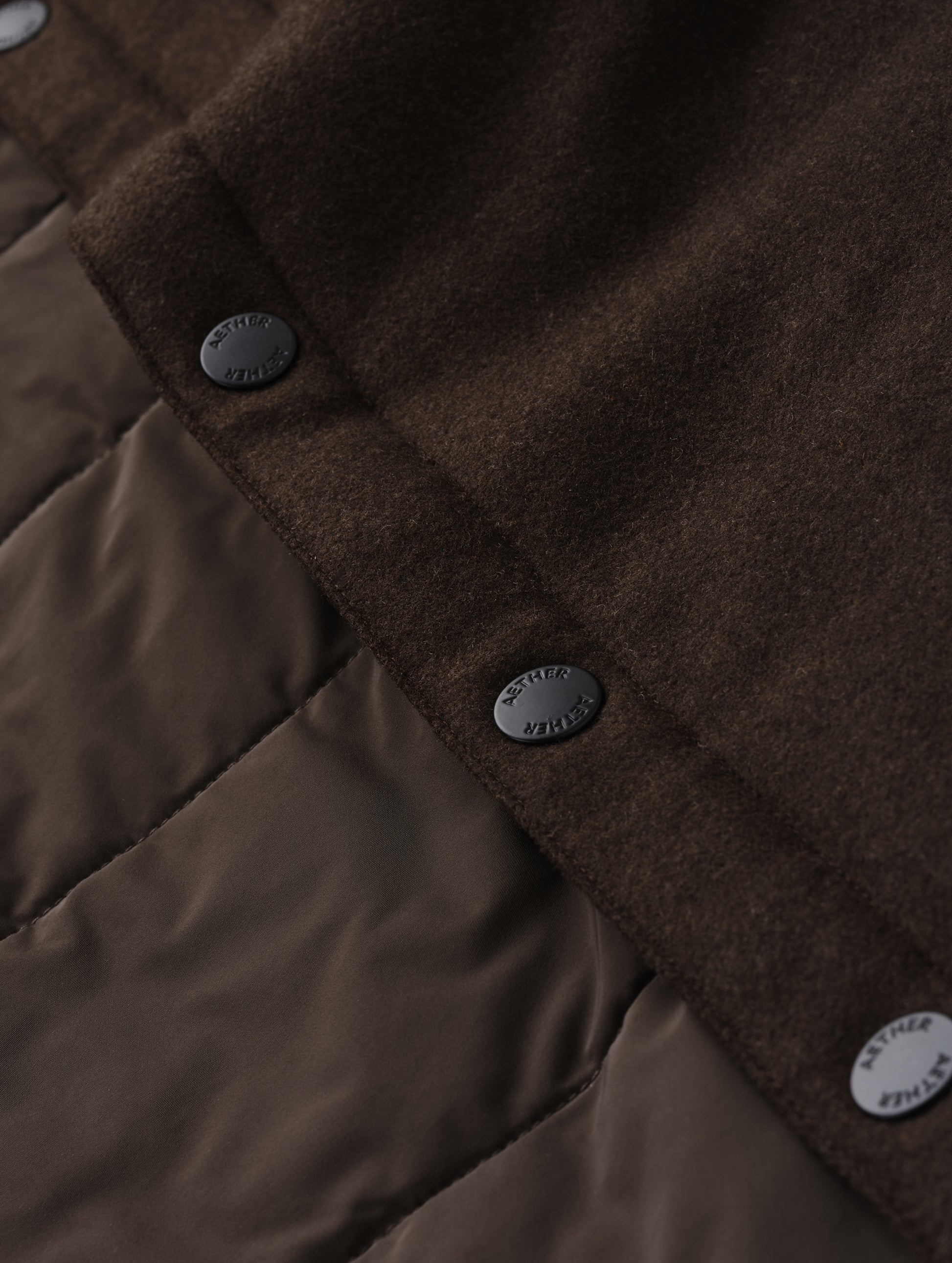 Closeup detailed view of the snap buttons and interior lining on Nova Insulated Button-Down in Ash Brown from AETHER Apparel.