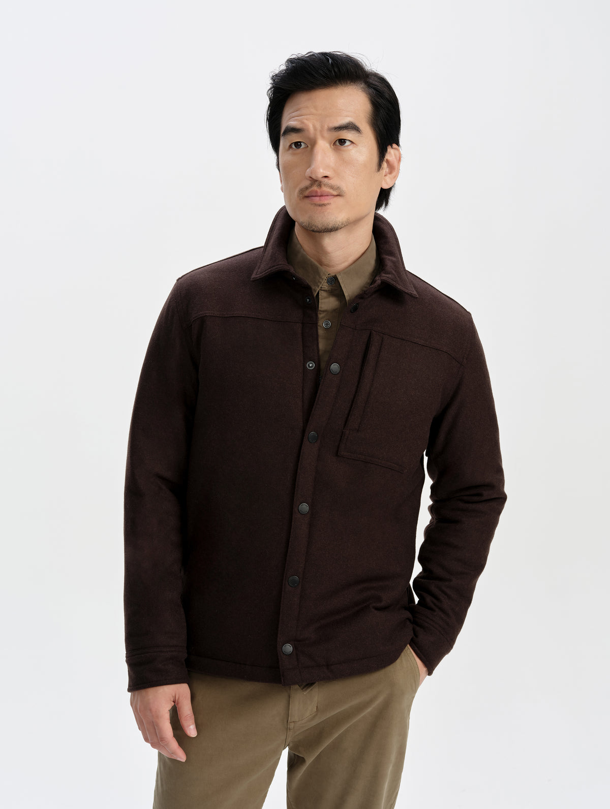 Front upper-body view of man wearing the Nova Insulated Button-Down in Ash Brown from AETHER Apparel.