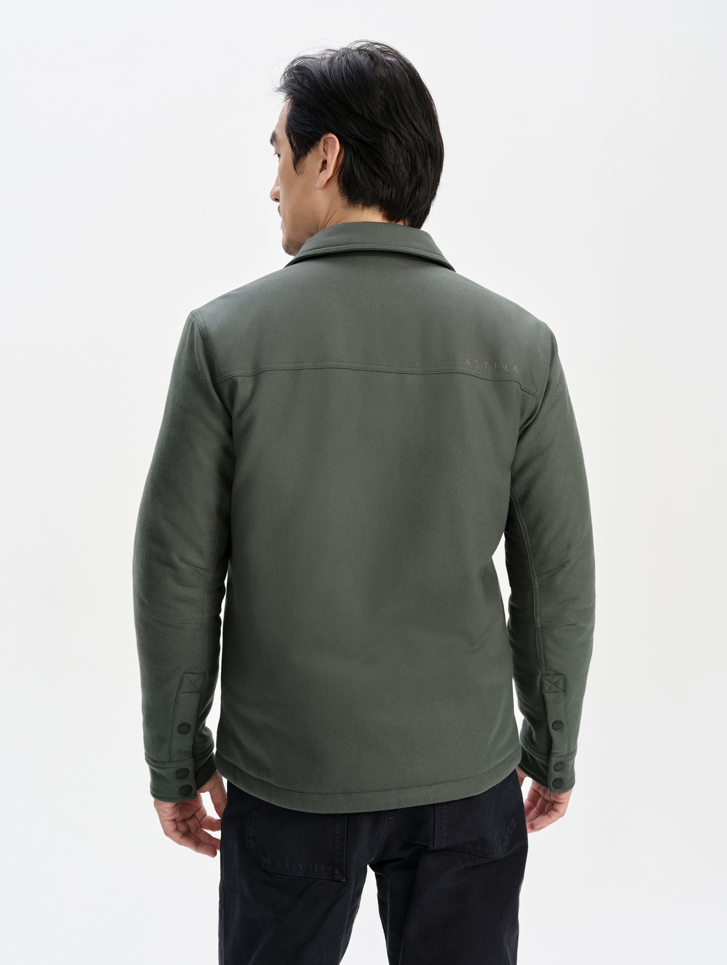 Rear upper-body view of man wearing the Nova Insulated Button-Down in Saville Green from AETHER Apparel.