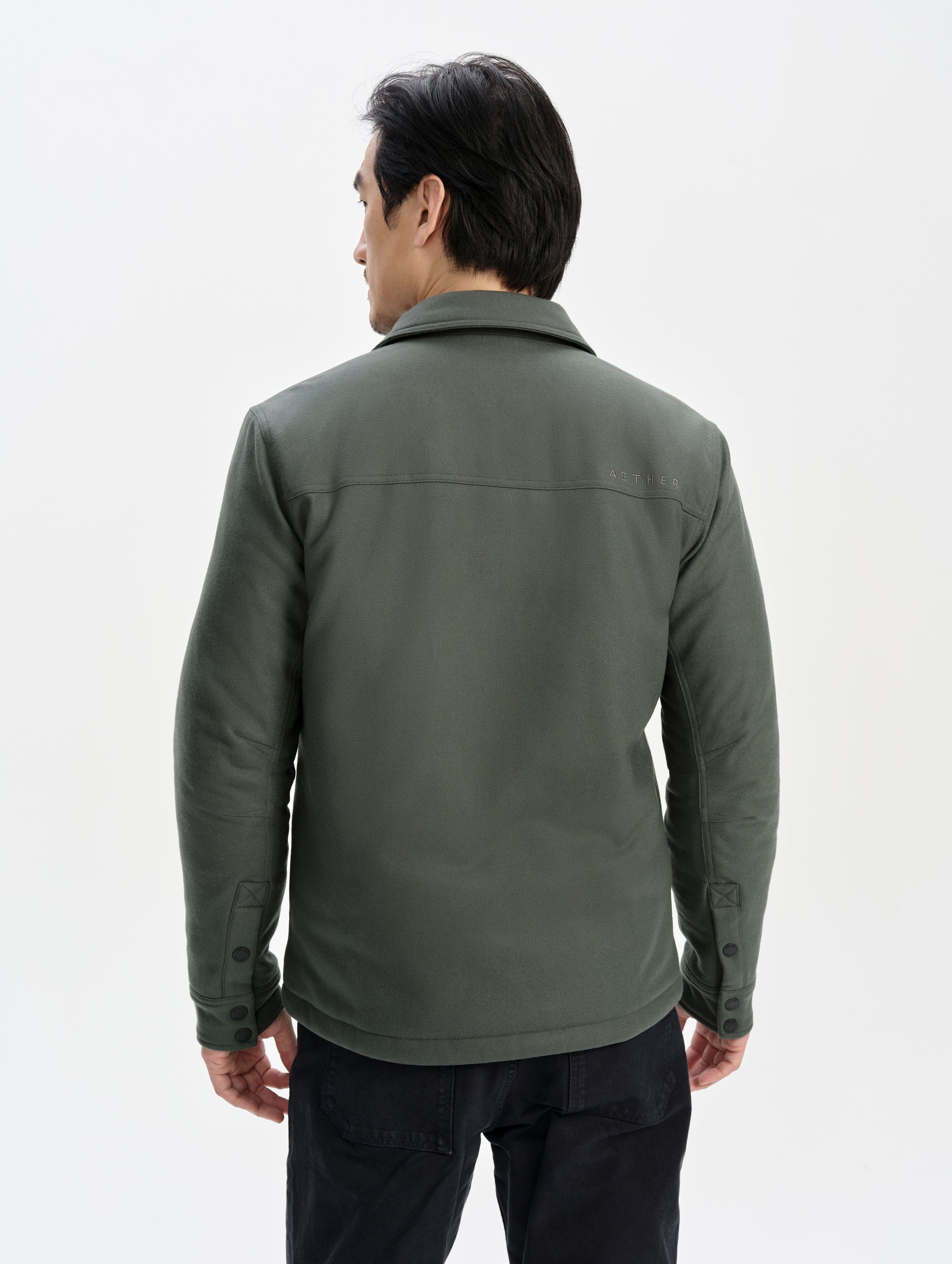 Rear upper-body view of man wearing the Nova Insulated Button-Down in Saville Green from AETHER Apparel.